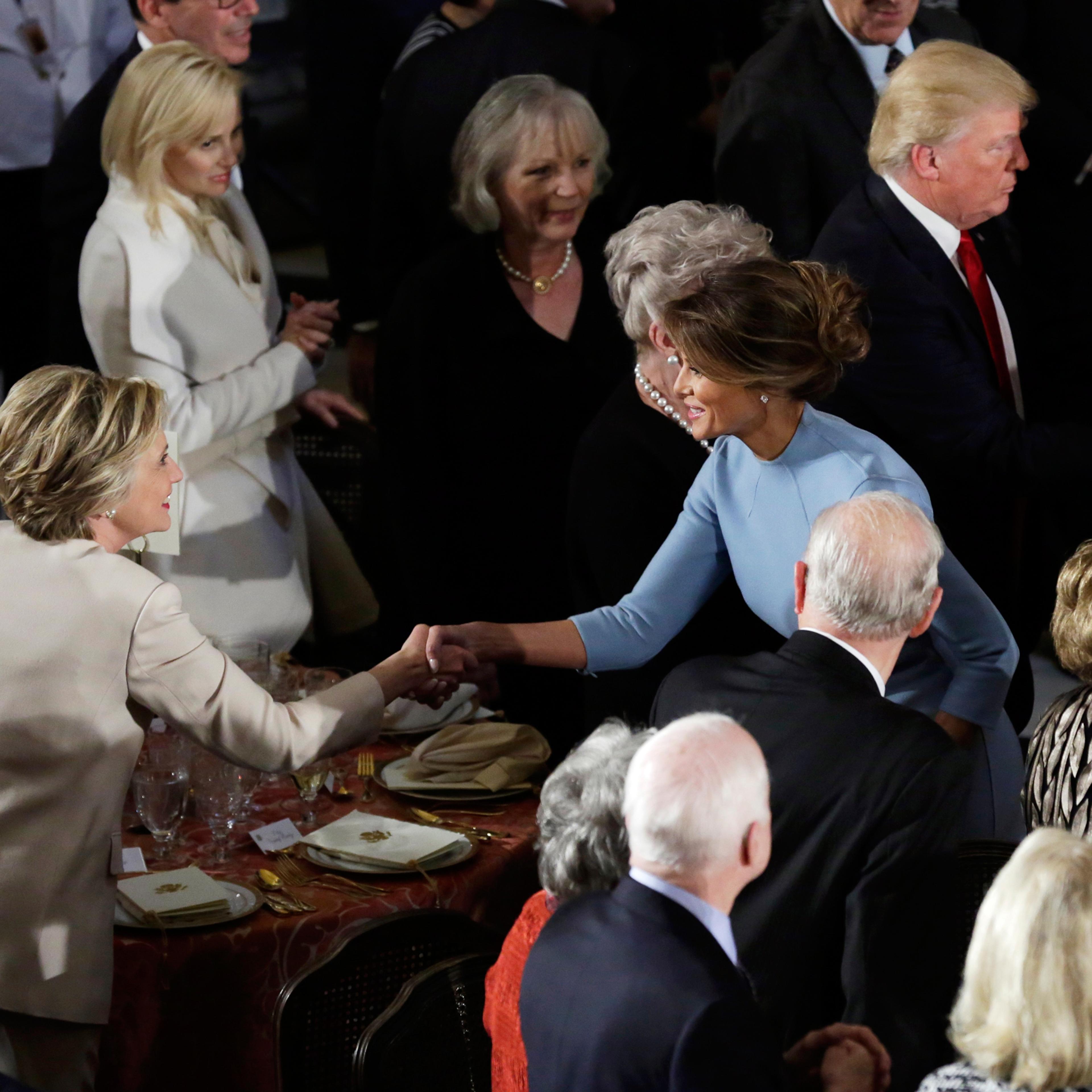 Former Democratic U.S. presidential nominee Hillary Clinton greets First lady Melania Trump as her husband Bill Clinton speaks with President Donald Trump during the Inaugural luncheon at the National Statuary Hall in Washington, U.S, January 20, 2017. R