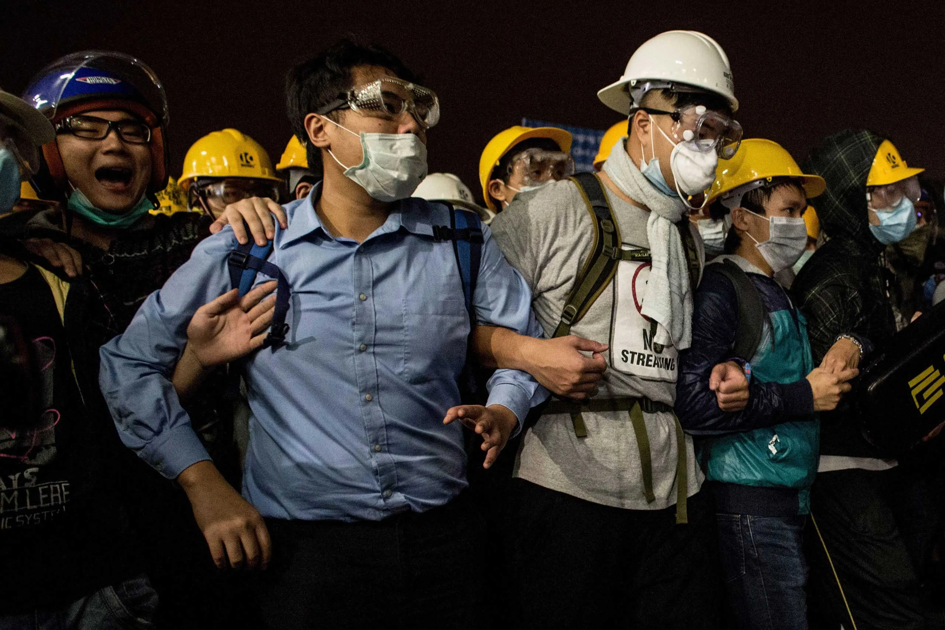 Pro-democracy activists join arms as they face off with police outside the Legislative Council building on Nov. 19, 2014 in Hong Kong.