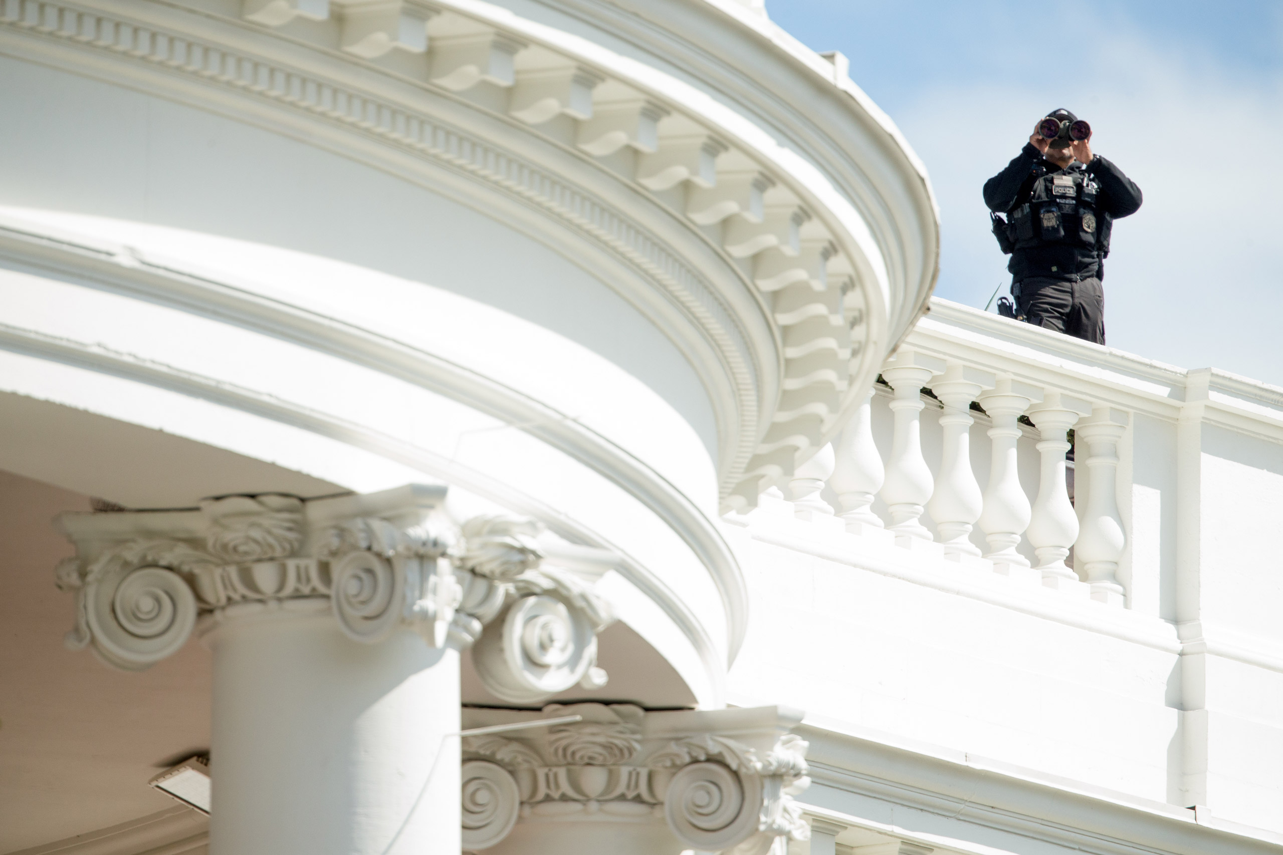 A member of the Secret Service stands on the roof of the White House during the White House Easter Egg Roll on the South Lawn in Washington, Monday, March 28, 2016. Thousands of children gathered at the White House for the annual Easter Egg Roll. This ye
