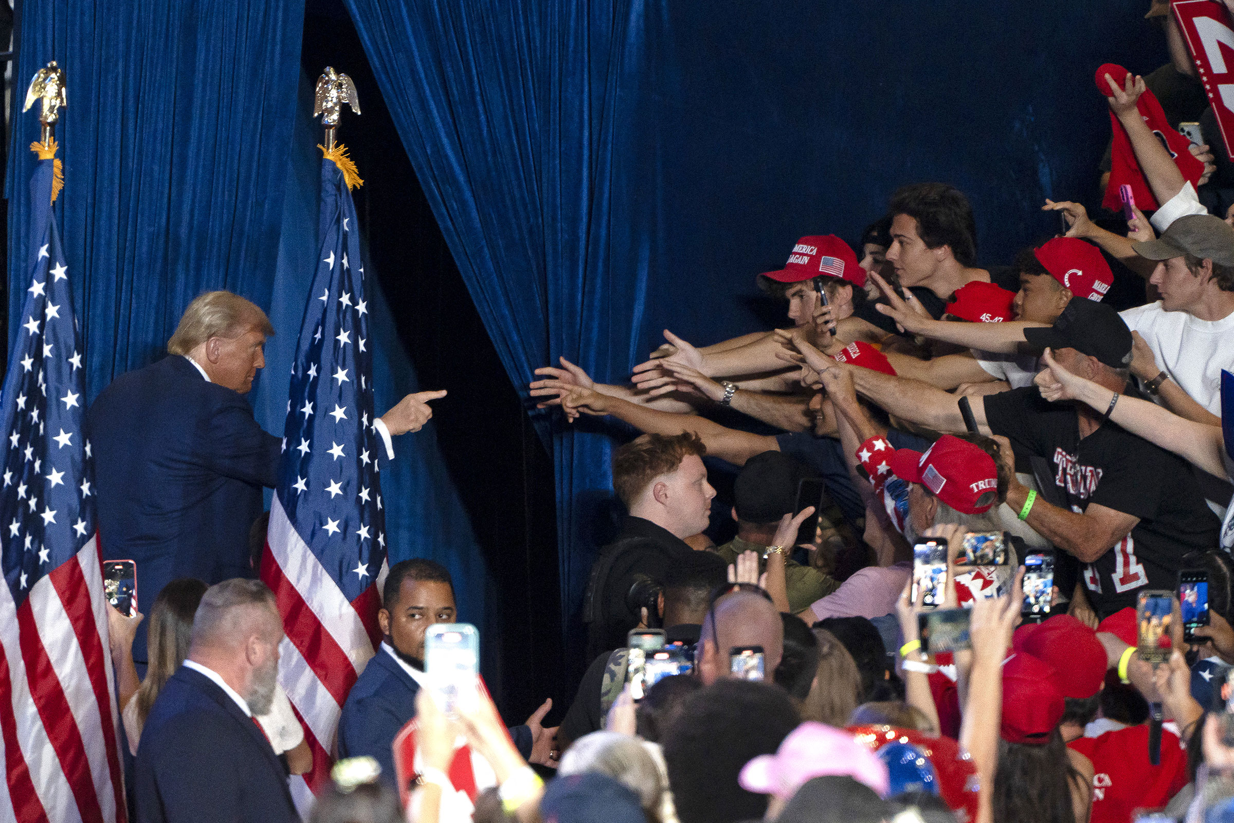 Trump gestures at supporters as he exits a campaign rally at Mullet Arena in Tempe, Ariz. on Oct. 24