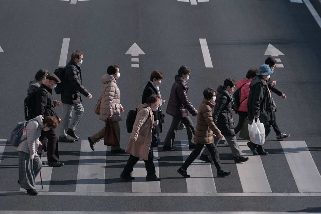 Pedestrians cross an intersection in the Itabashi district of Tokyo, Japan, on Friday, Jan. 19, 2024.