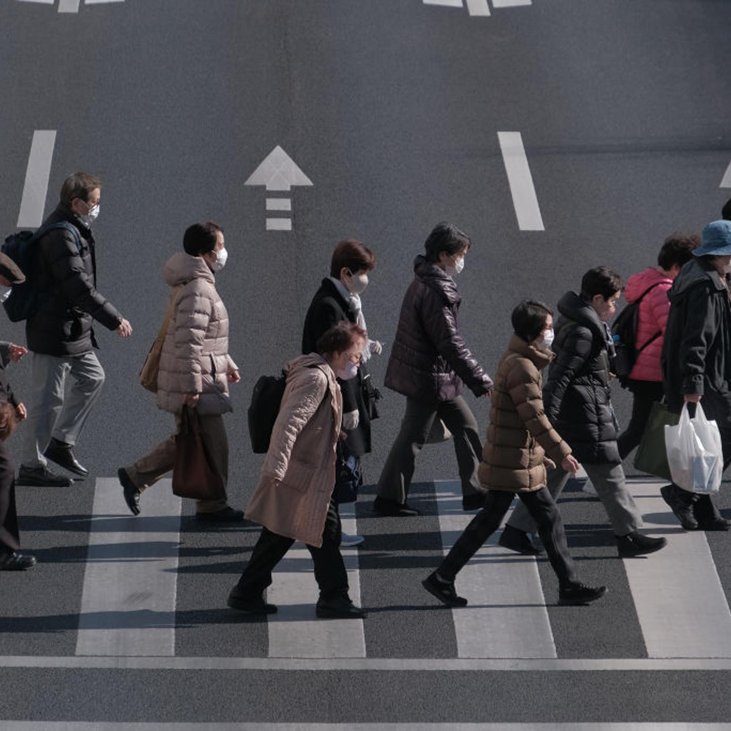 Pedestrians cross an intersection in the Itabashi district of Tokyo, Japan, on Friday, Jan. 19, 2024.