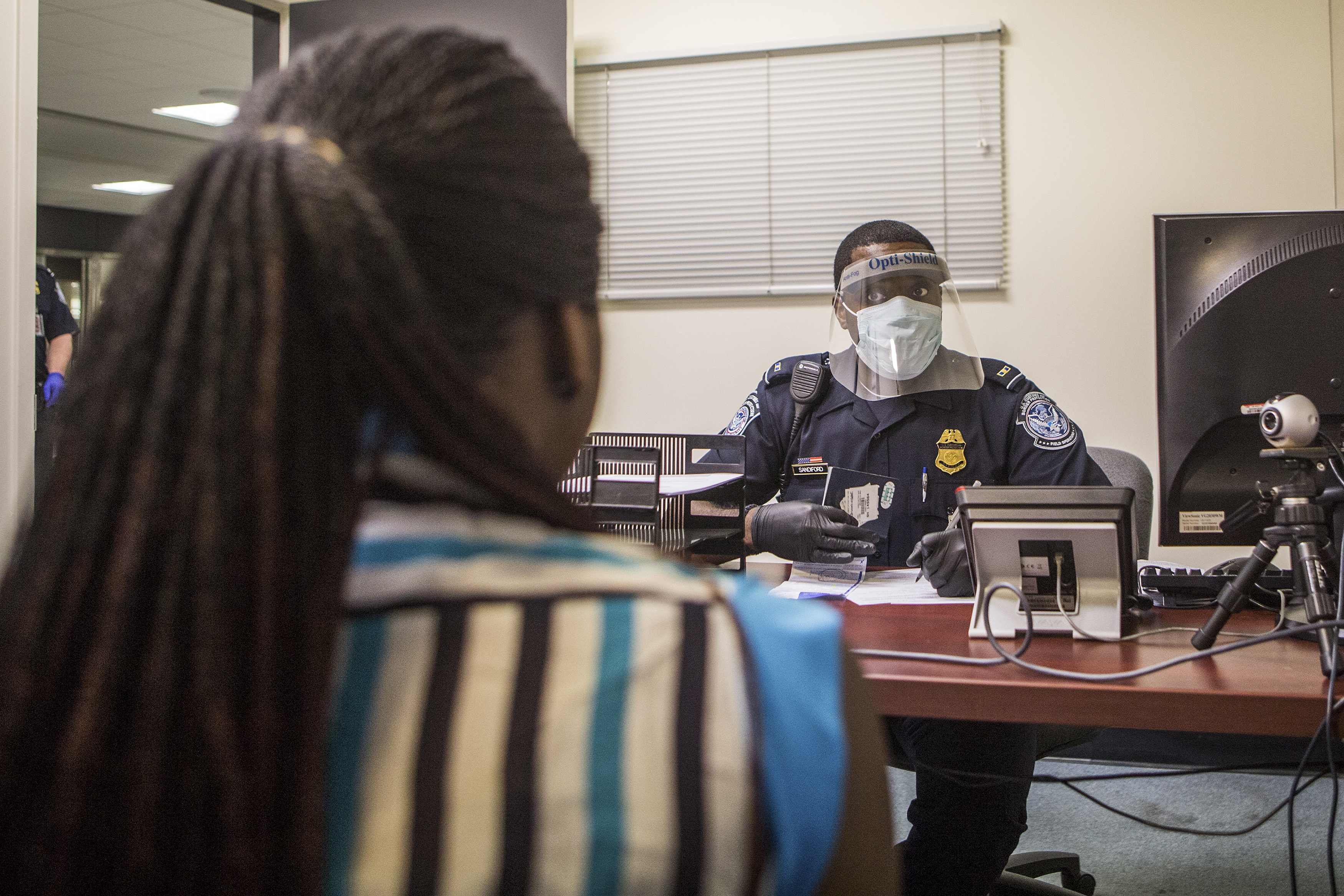 An Office of Field Operations Officer conducts an interview with a passenger at Washington Dulles International Airport