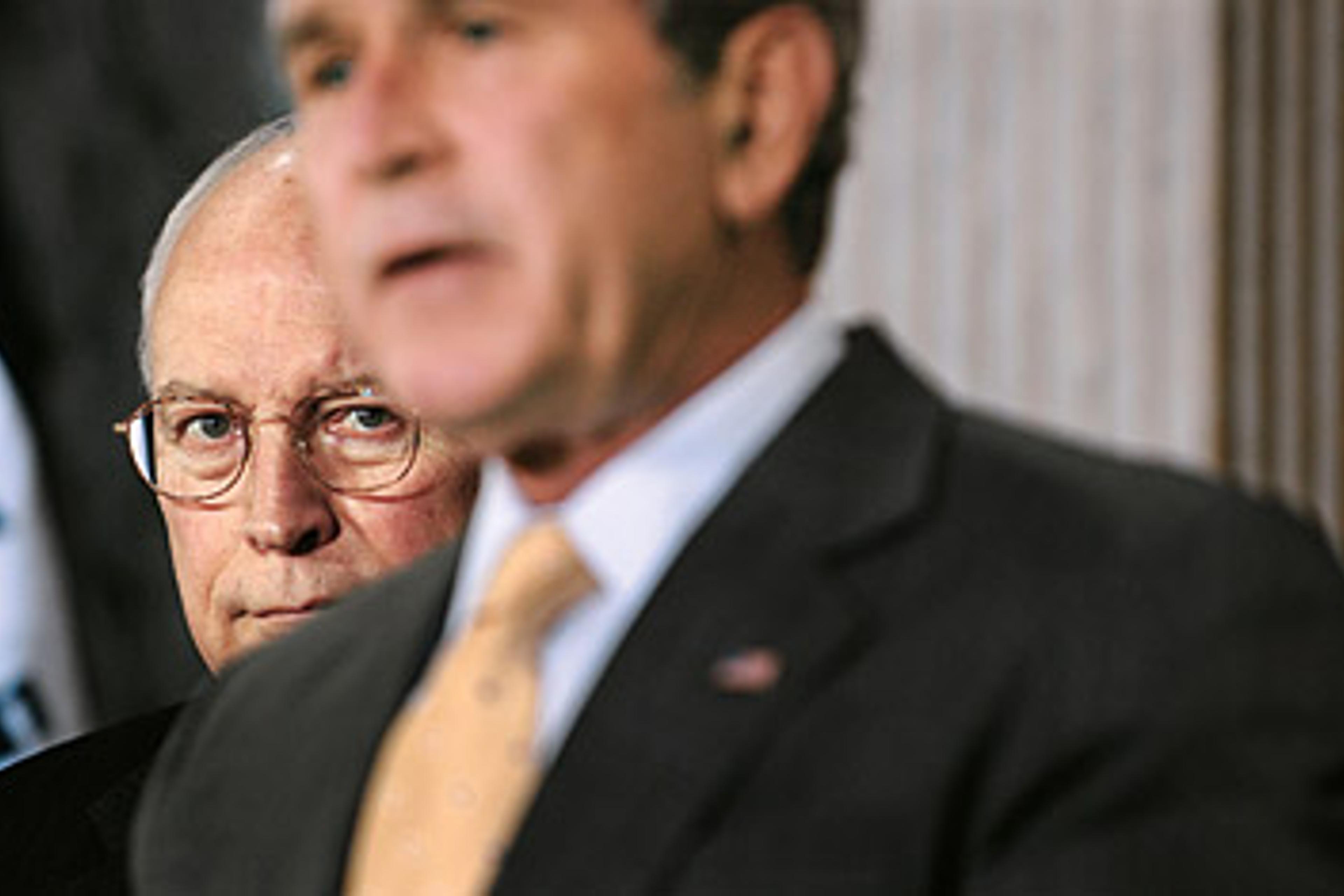 Vice President Dick Cheney listens as President George W. Bush makes a statement in the "Cash Room" in the Treasury building.