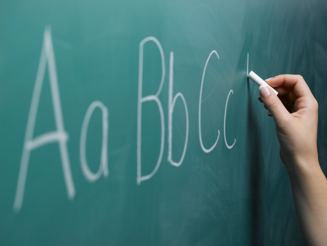 Writing by hand on chalkboard