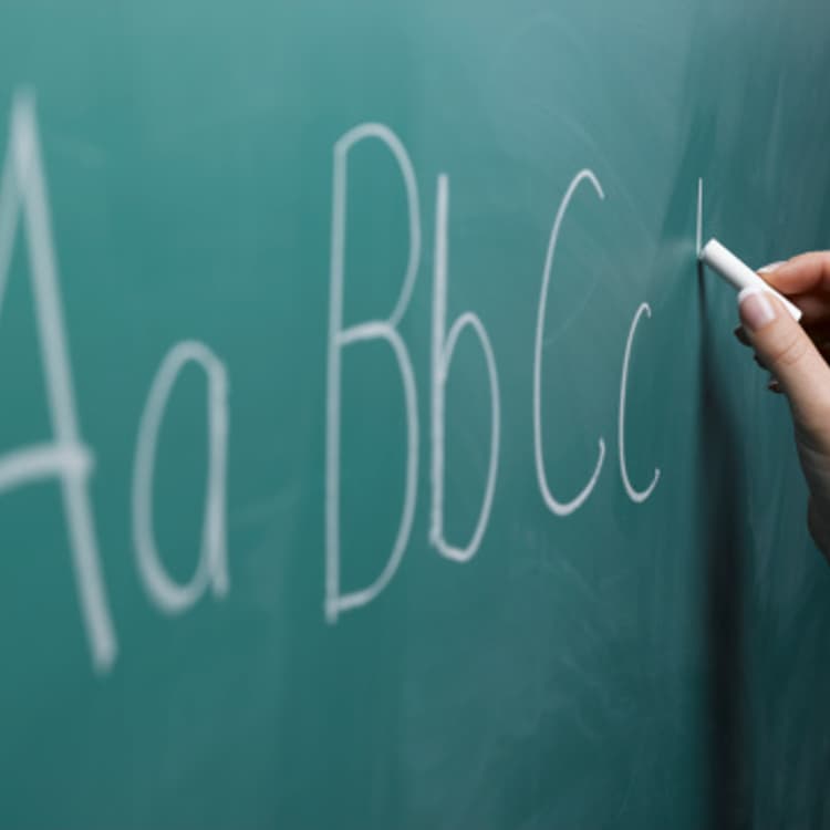 Writing by hand on chalkboard