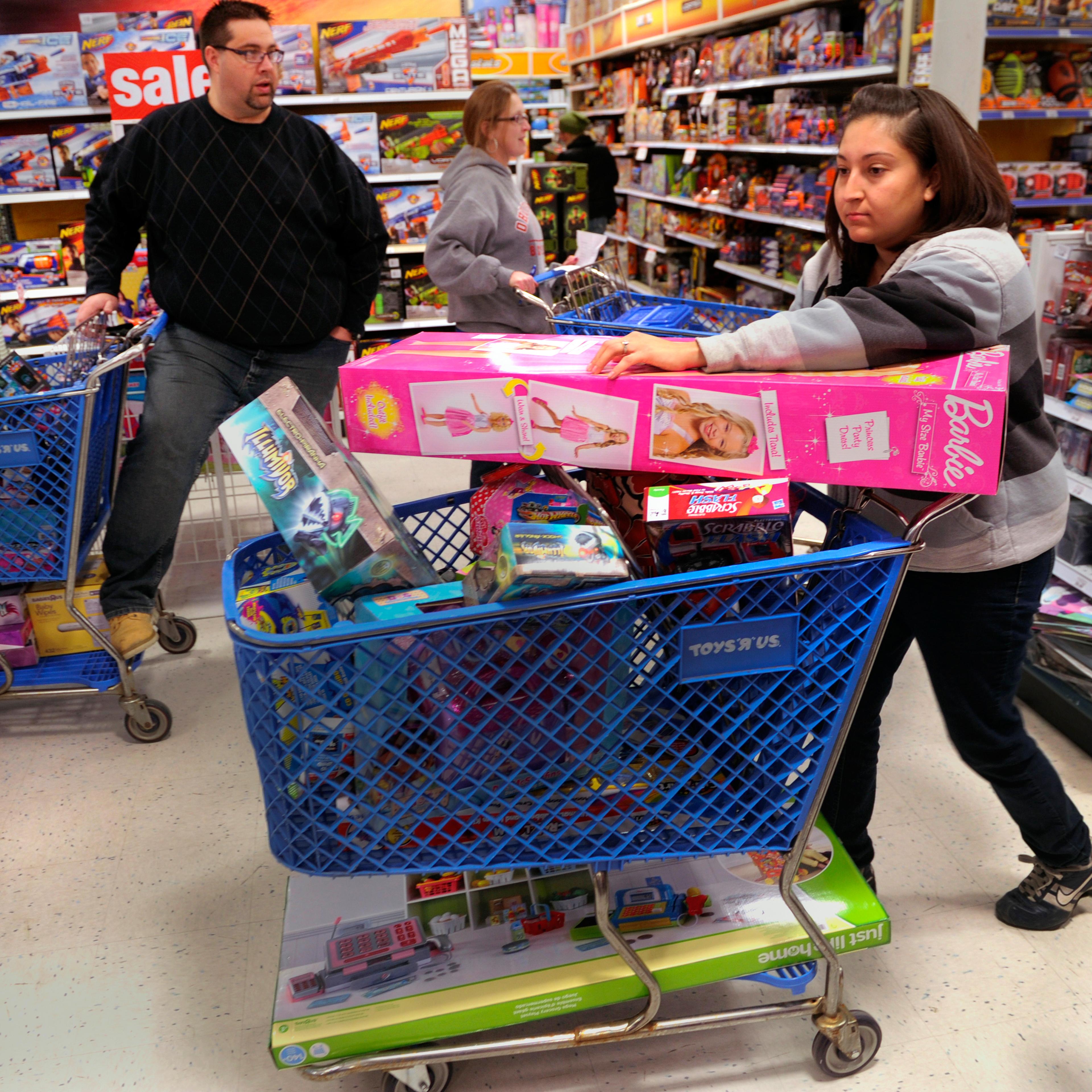 Jennifer Martinez filled a shopping cart with toys at the Toys R Us store on County Line Road in Arapahoe County Thursday night, November 28, 2013.