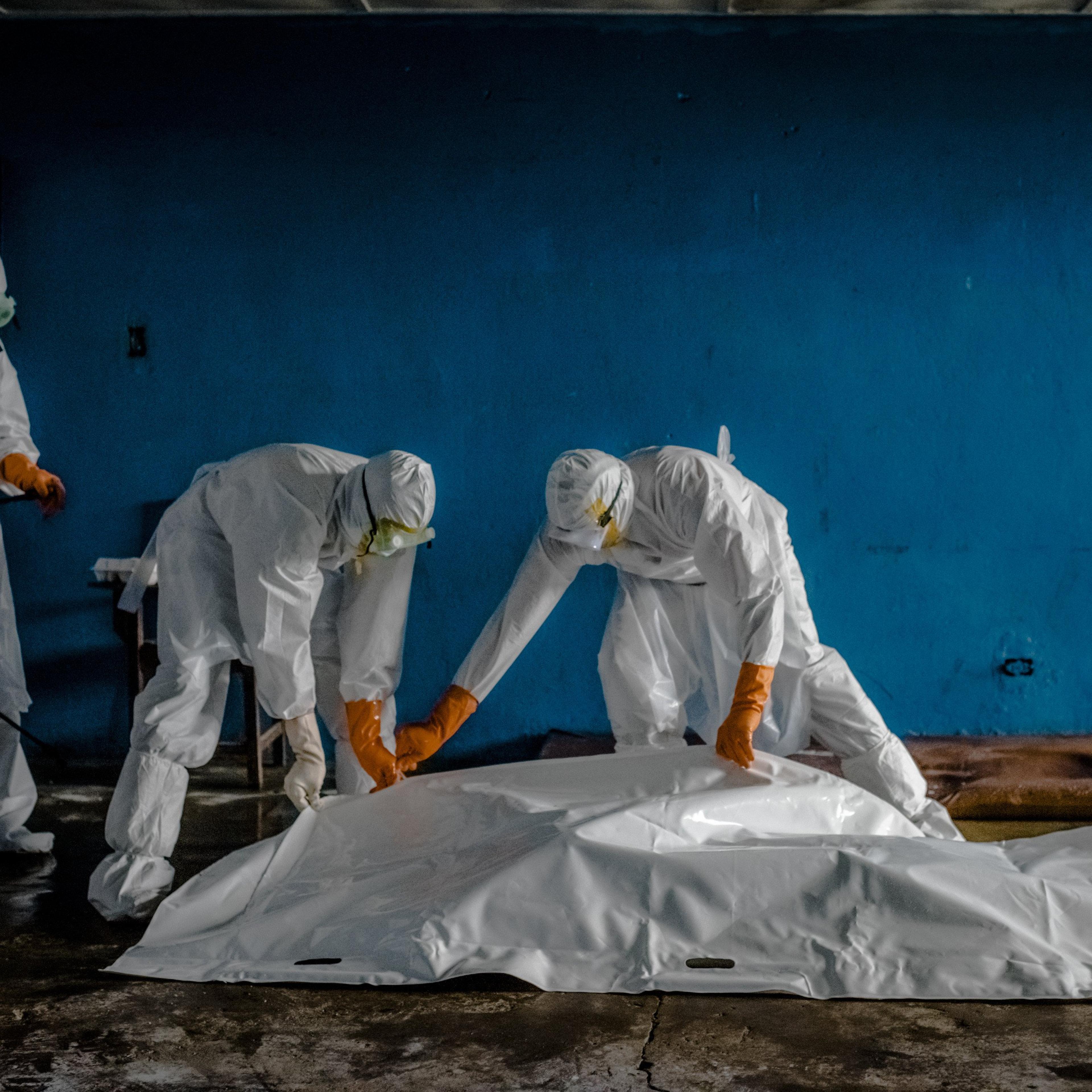 A burial team in protective clothing retrieves the body of an Ebola victim from an isolation ward in the West Point neighborhood of Monrovia, the capital of Liberia on Aug. 28, 2014.