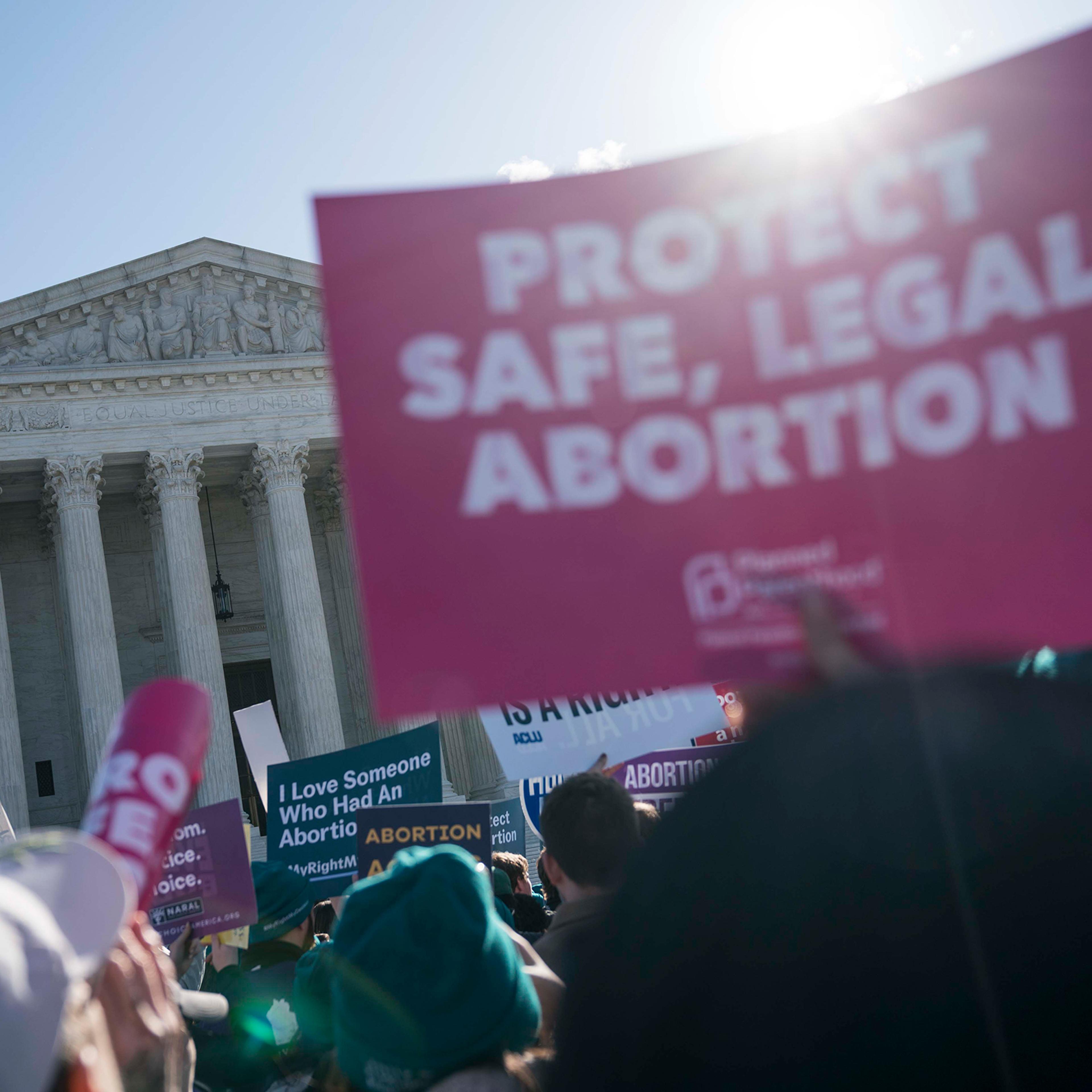 People participate in an abortion rights rally outside of the Supreme Court on March 4
