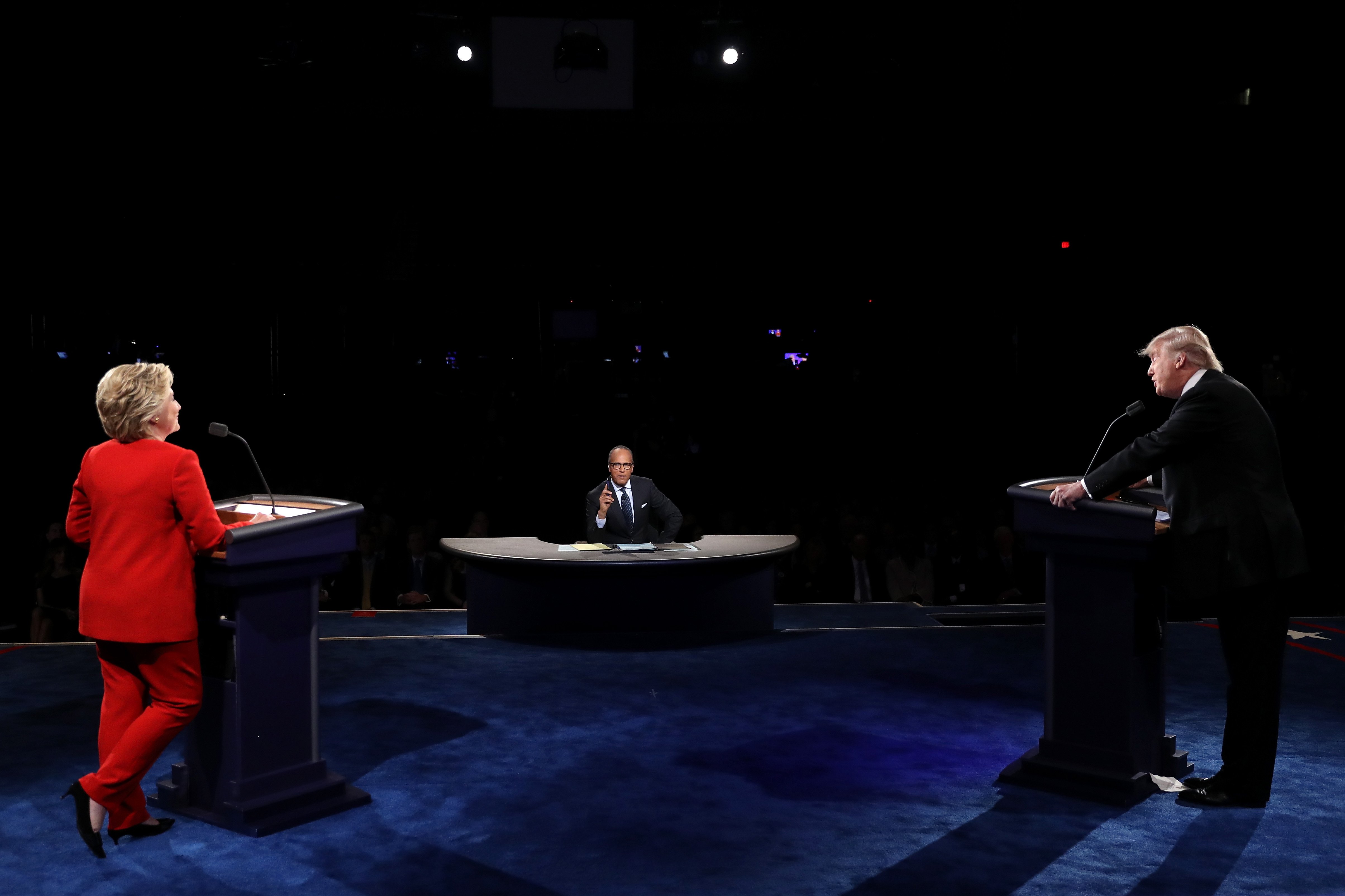 Republican presidential nominee Donald Trump debates Democratic presidential nominee Hillary Clinton as moderator Lester Holt looks on during the presidential debate at Hofstra University on Sept. 26, 2016 in Hempstead, New York.