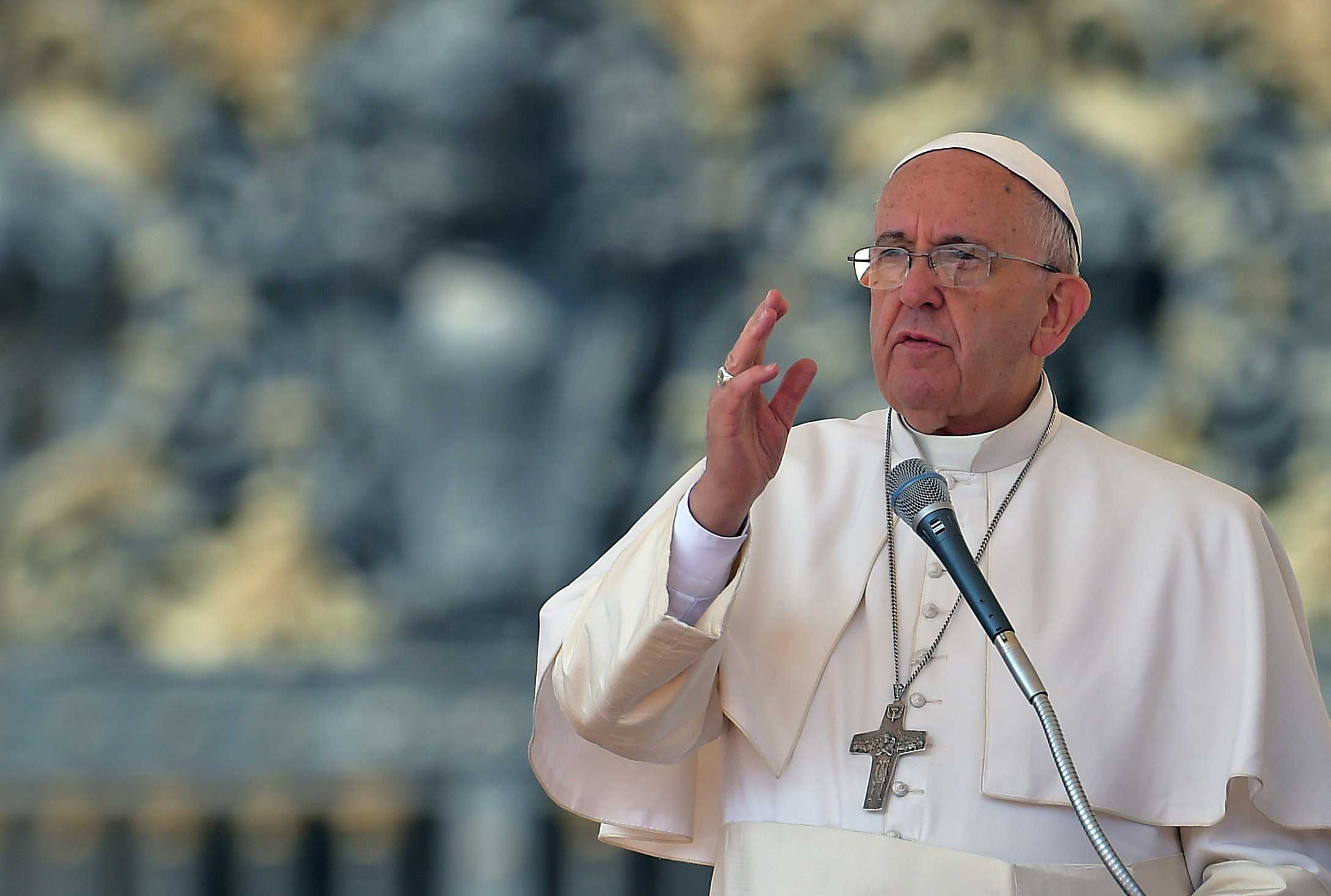 Pope Francis blesses the faithful during his weekly general audience at the Vatican on April 15, 2015.
