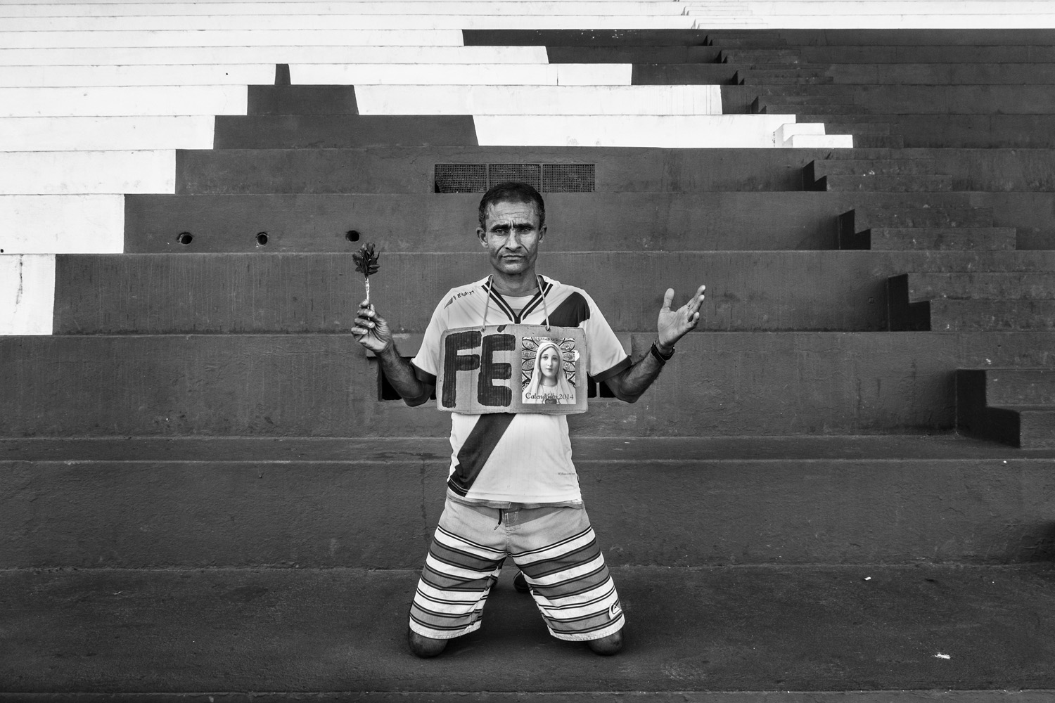RIO DE JANEIRO, BRAZIL - JUNE 2014: Carlos Henrique do Nascimento, 46, is known as Caíque. He is a bricklayer and goes to all the games Vasco play. Caíque is reputed to bring luck to the team. Vasco is his religion. He goes to all the games with a banner