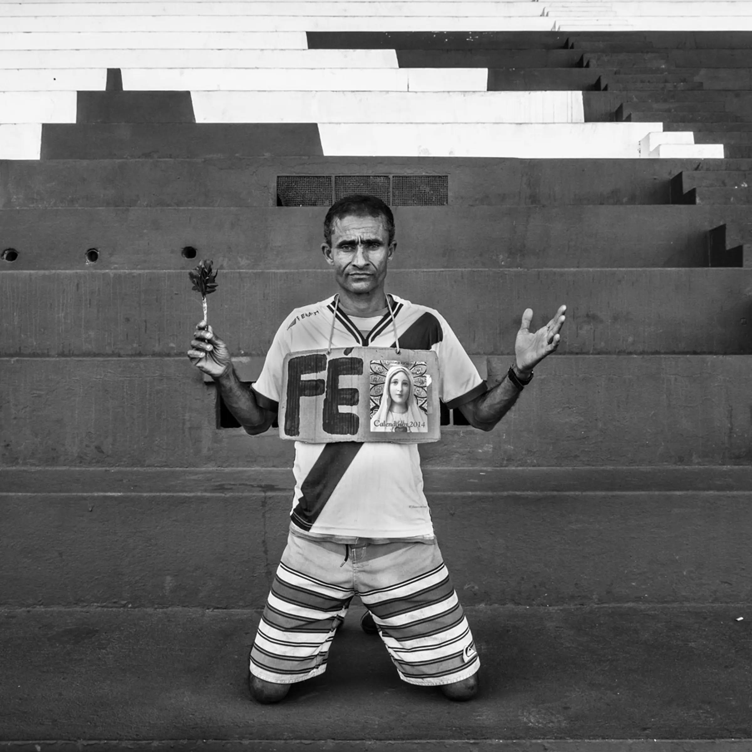 RIO DE JANEIRO, BRAZIL - JUNE 2014: Carlos Henrique do Nascimento, 46, is known as Caíque. He is a bricklayer and goes to all the games Vasco play. Caíque is reputed to bring luck to the team. Vasco is his religion. He goes to all the games with a banner