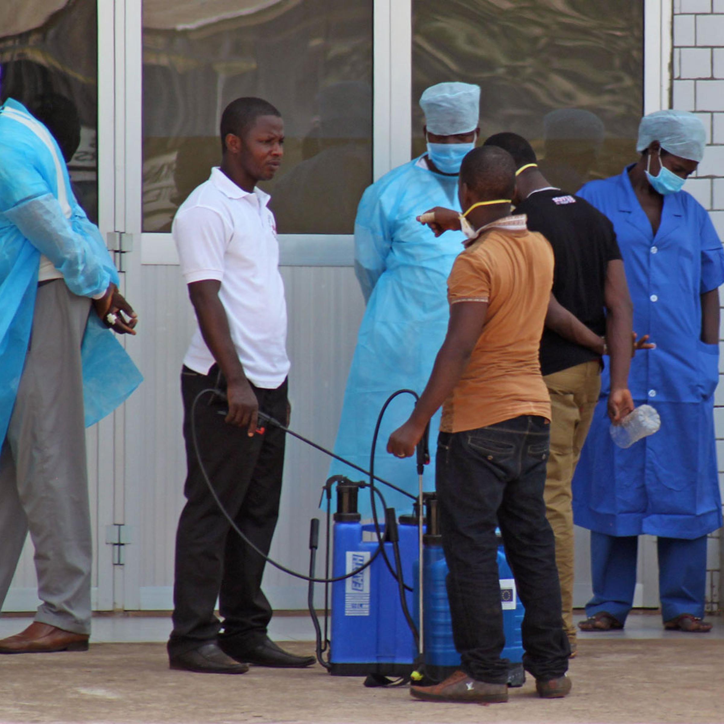 Medical personnel at the emergency entrance of a hospital receive suspected Ebola virus patients in Conakry, Guinea, March 29, 2014.