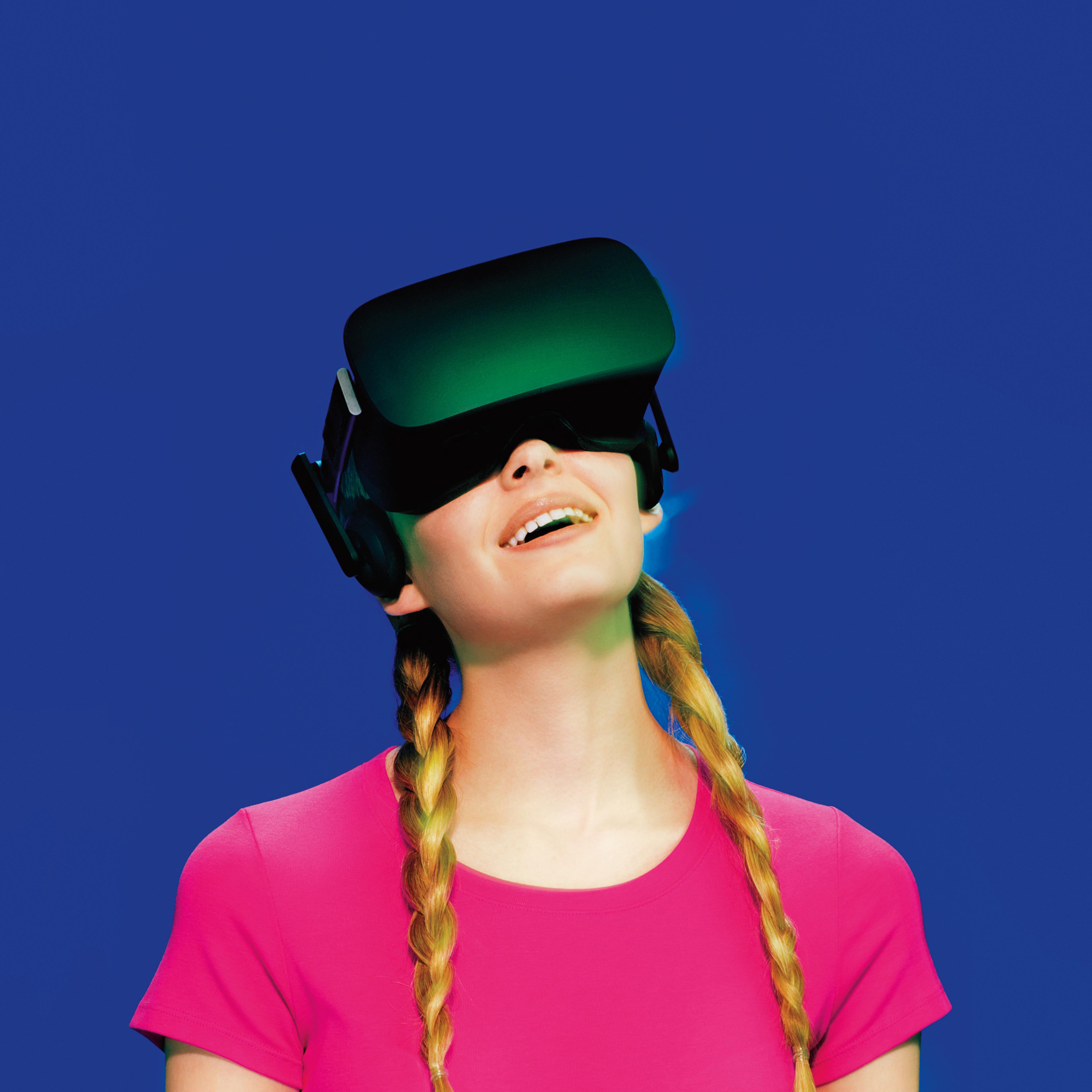 A young woman wearing Oculus Rift virtual reality goggles