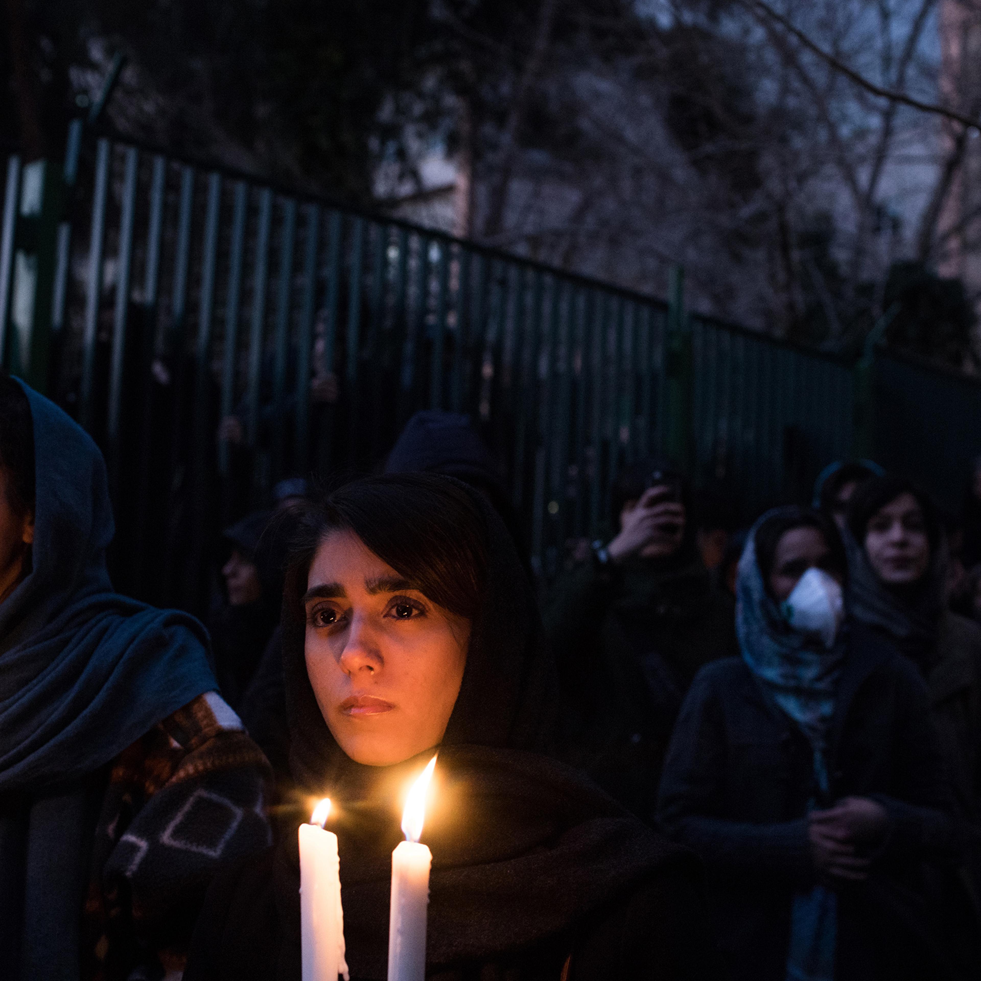 Demonstrators at a vigil in Tehran on Jan. 11 mourn victims of a plane crash caused by Iran’s military