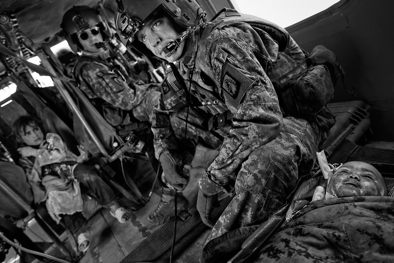 Flight medic Sgt. Billy Raines pauses after treating the wounds of a 4-year-old Afghan girl who was severely burned after a pressure cooker exploded in her home in Helmand Province, May 5, 2011.