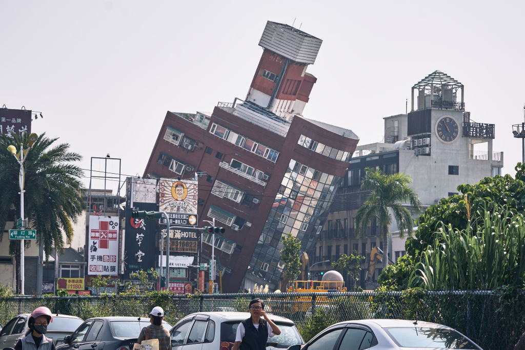 A damaged building, back, following an earthquake in Hualien, Taiwan, on Thursday, April 4, 2024.