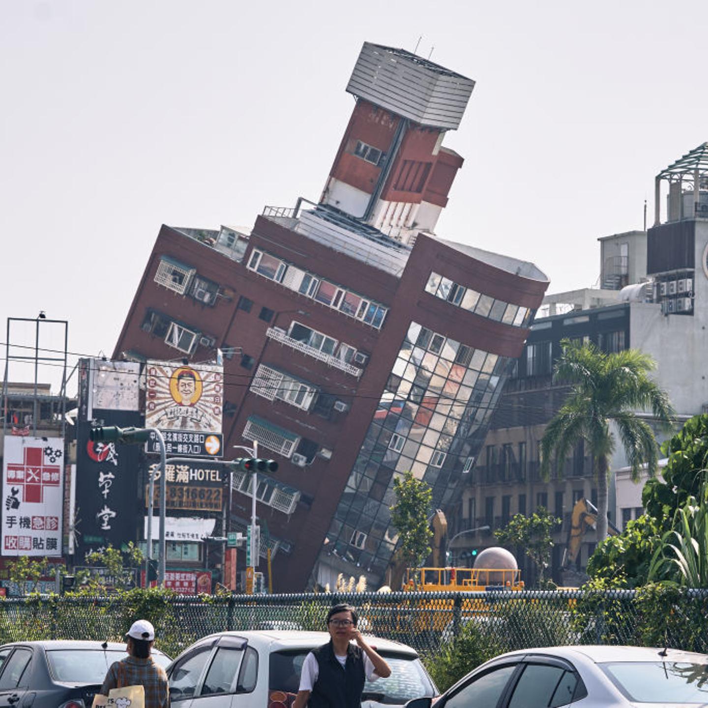A damaged building, back, following an earthquake in Hualien, Taiwan, on Thursday, April 4, 2024.