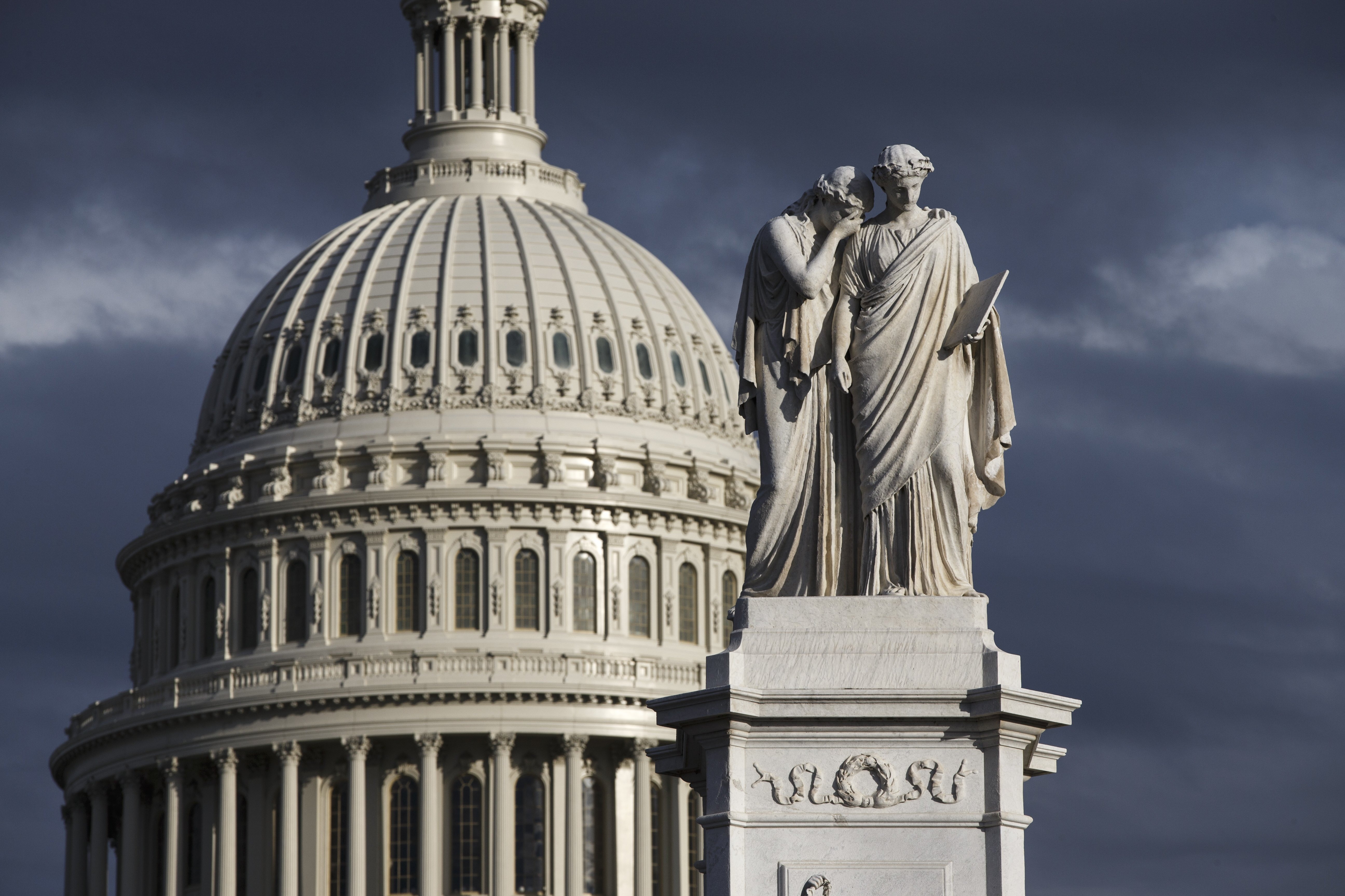 The late afternoon sun illuminates the U.S. Capitol and the Peace Monument.