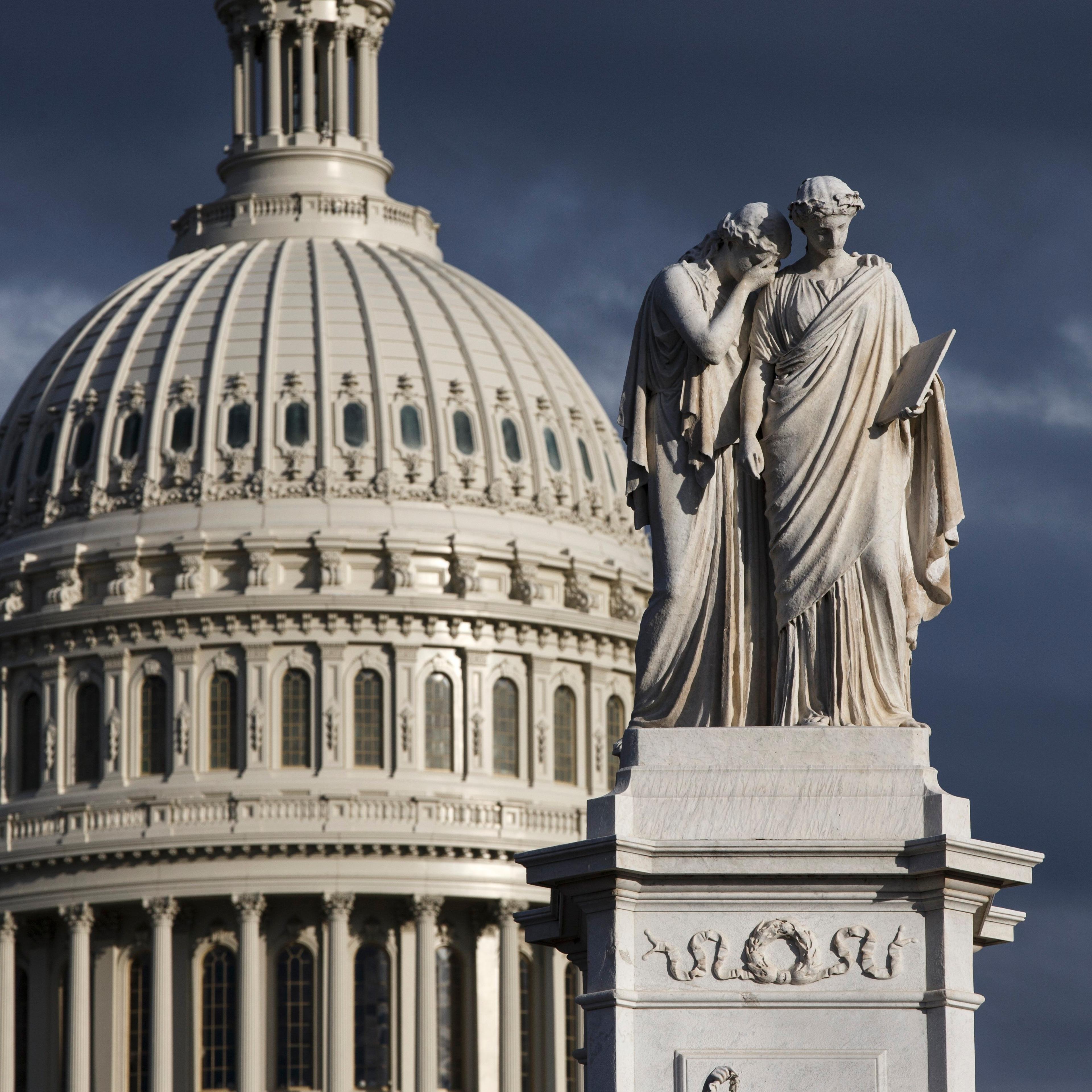 The late afternoon sun illuminates the U.S. Capitol and the Peace Monument.