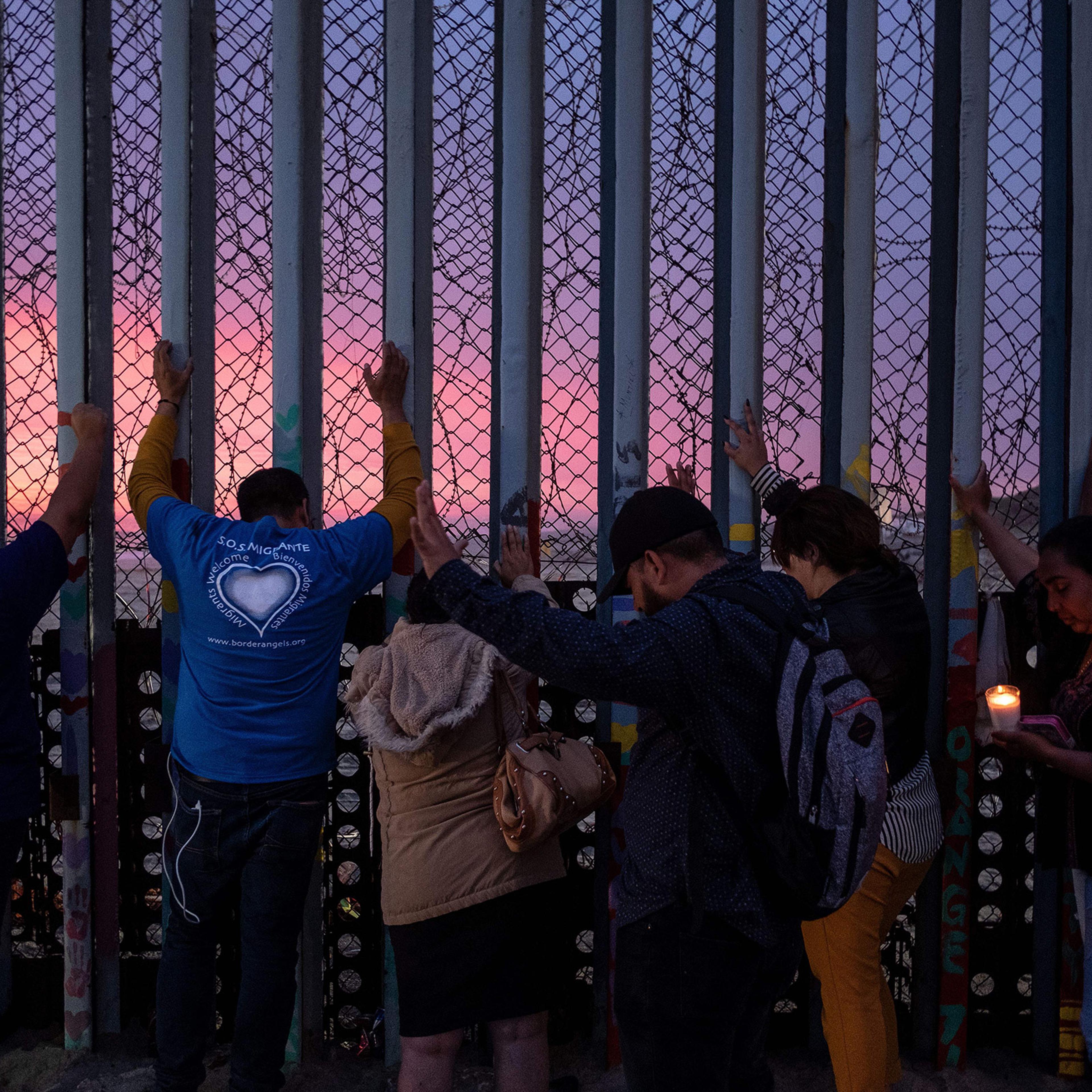 Migrants, advocates and attendees take part in an event called "Clamor for those who didn't achieve the dream" at the U.S.-Mexico border in Playas de Tijuana, Baja California state, Mexico, on June 29, 2019.
