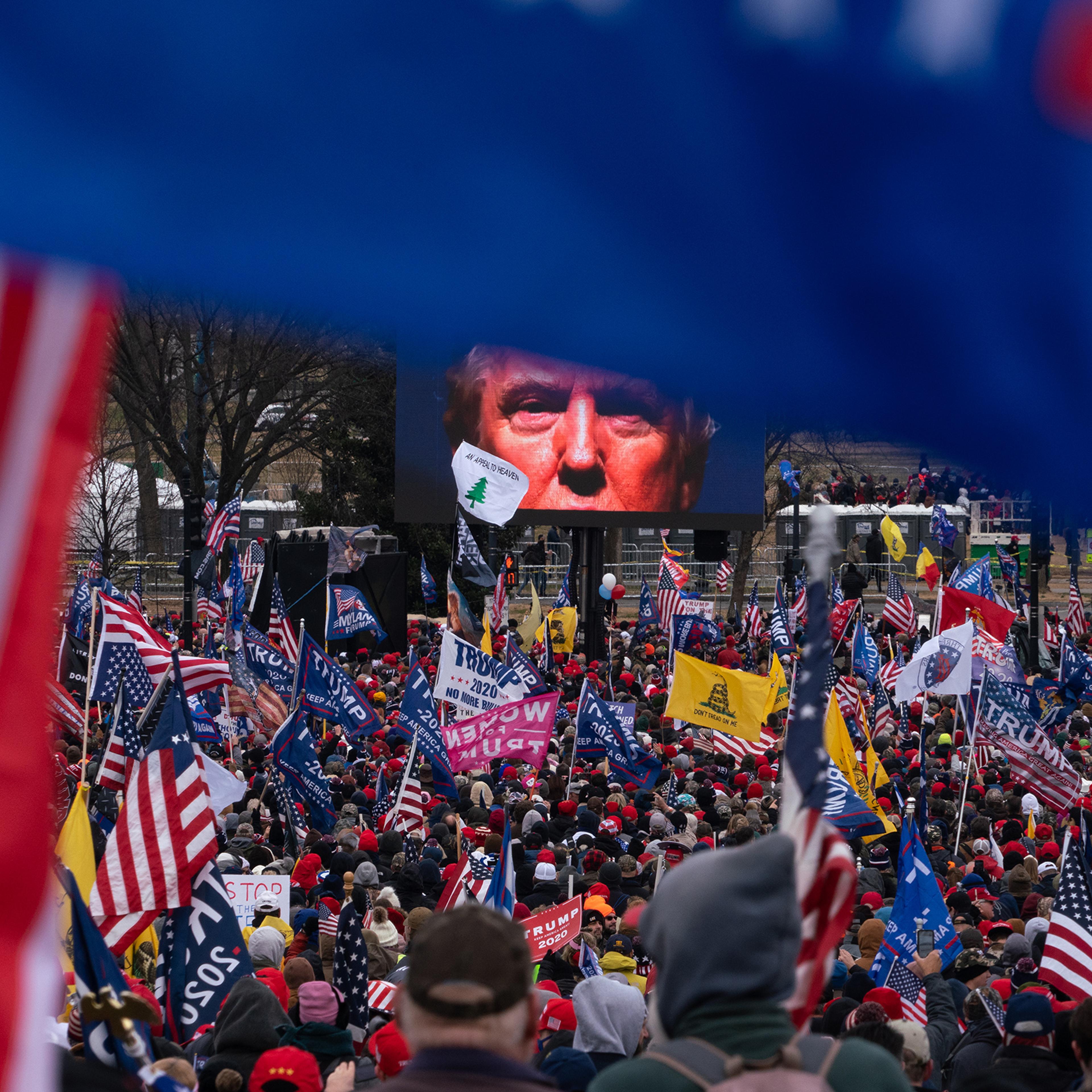 President Trump appears on a large screen at the "Save America Rally" on Jan. 6, the day that Congress was slated to certify the electoral victory for his opponent. Following his inflammatory speech, rioters stormed the Capitol.