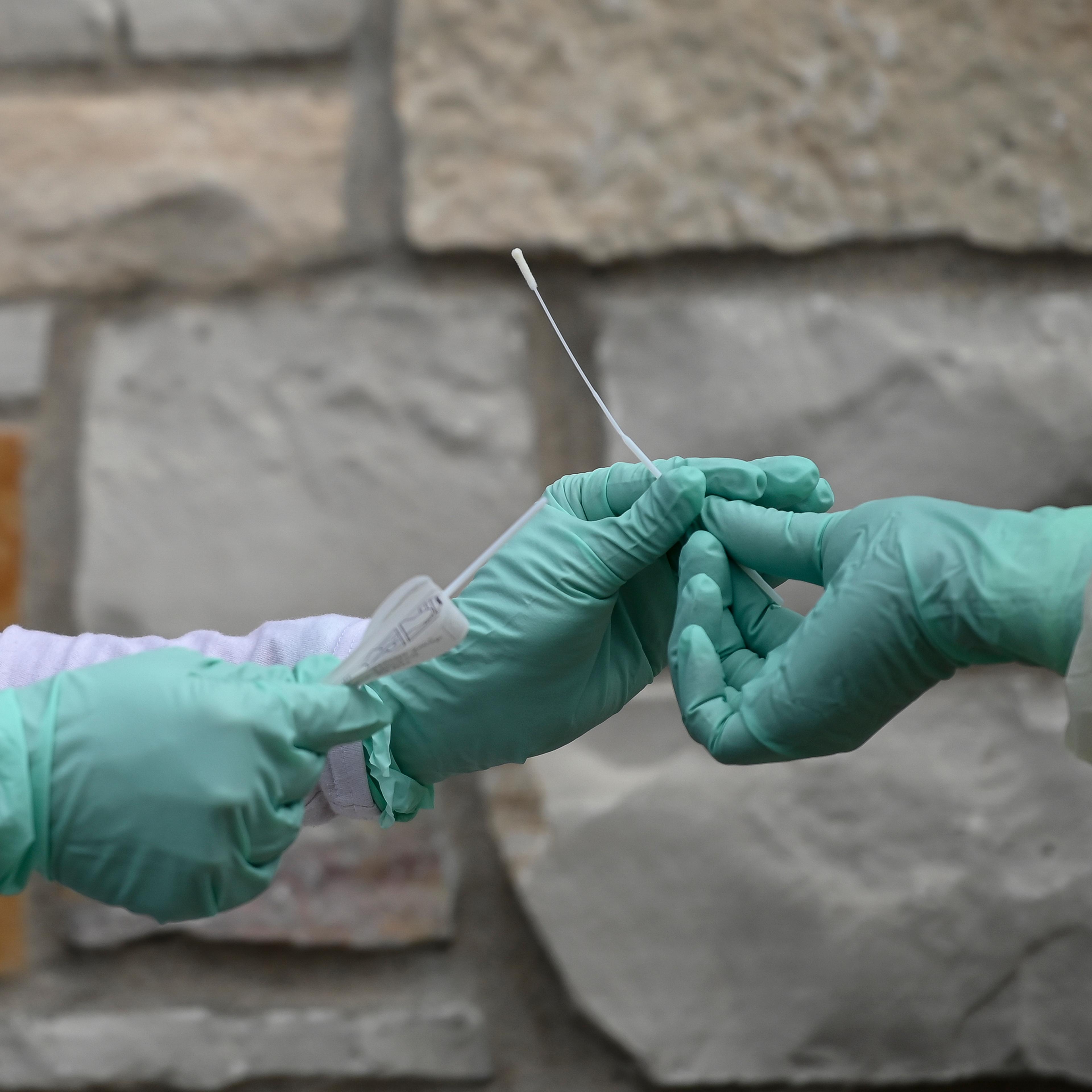 Fridley health workers demonstate COVID-19 drive-up testing