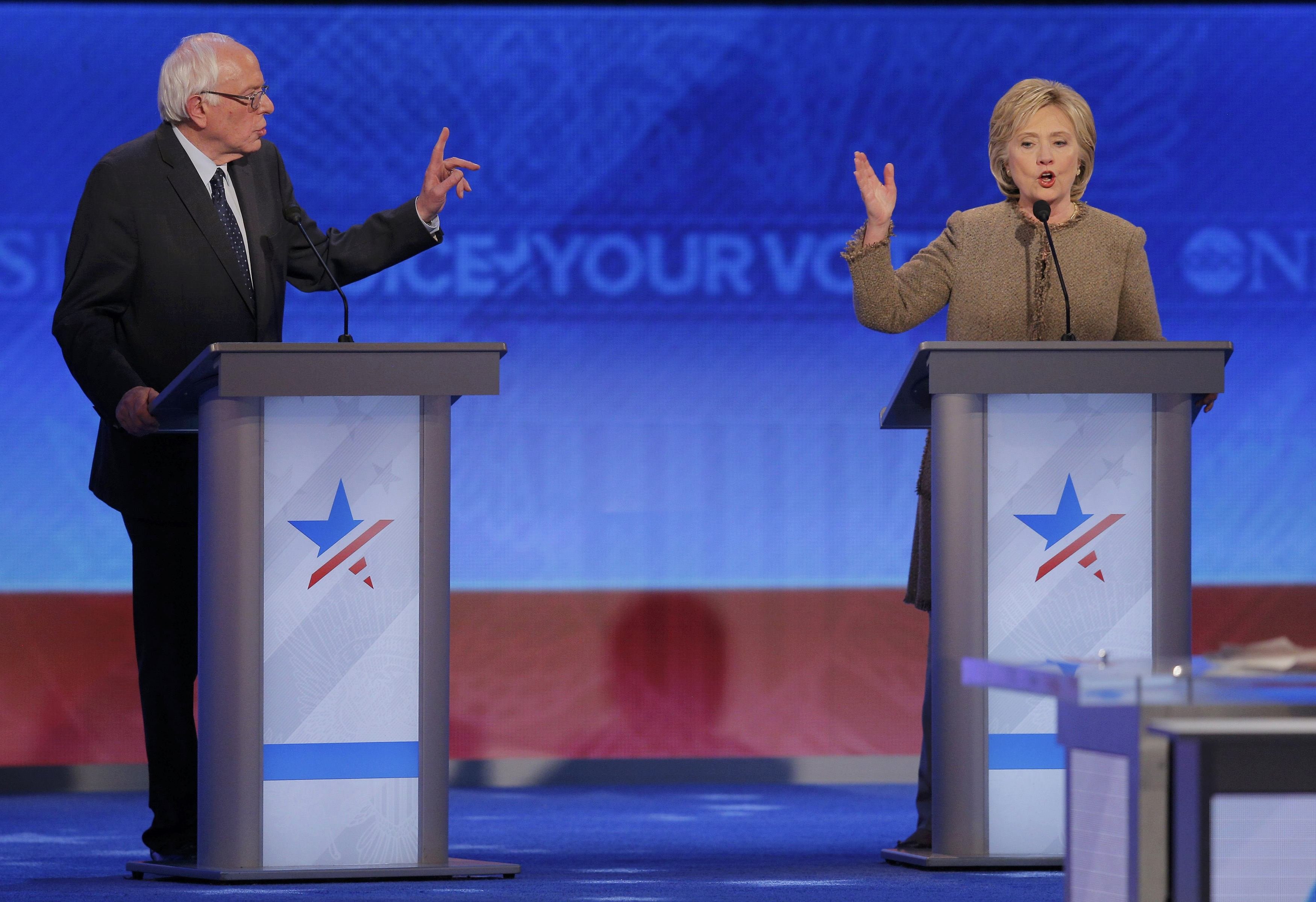 Democratic U.S. presidential candidates Sanders and Clinton discuss an issue at the Democratic presidential candidates debate at St. Anselm College in Manchester