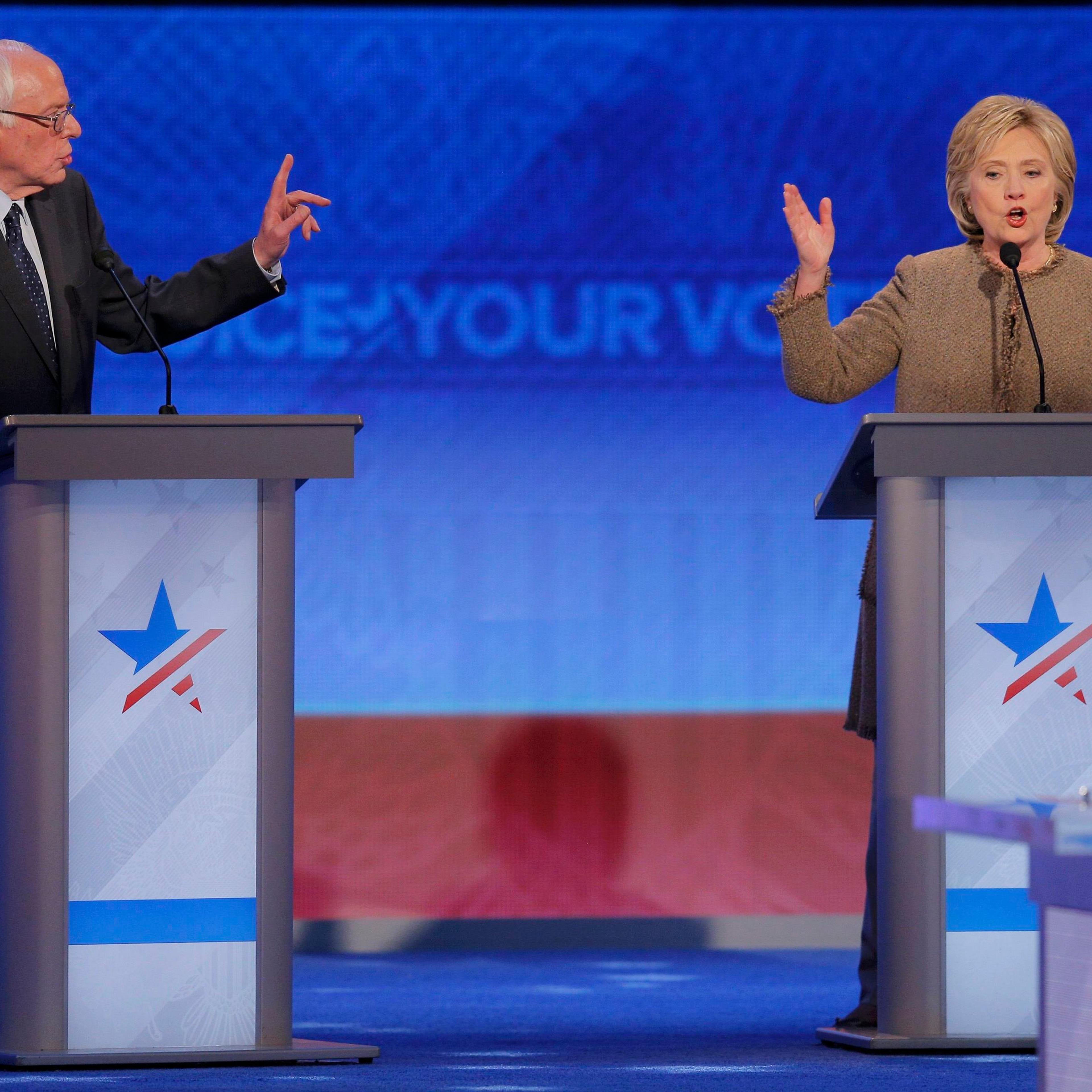 Democratic U.S. presidential candidates Sanders and Clinton discuss an issue at the Democratic presidential candidates debate at St. Anselm College in Manchester