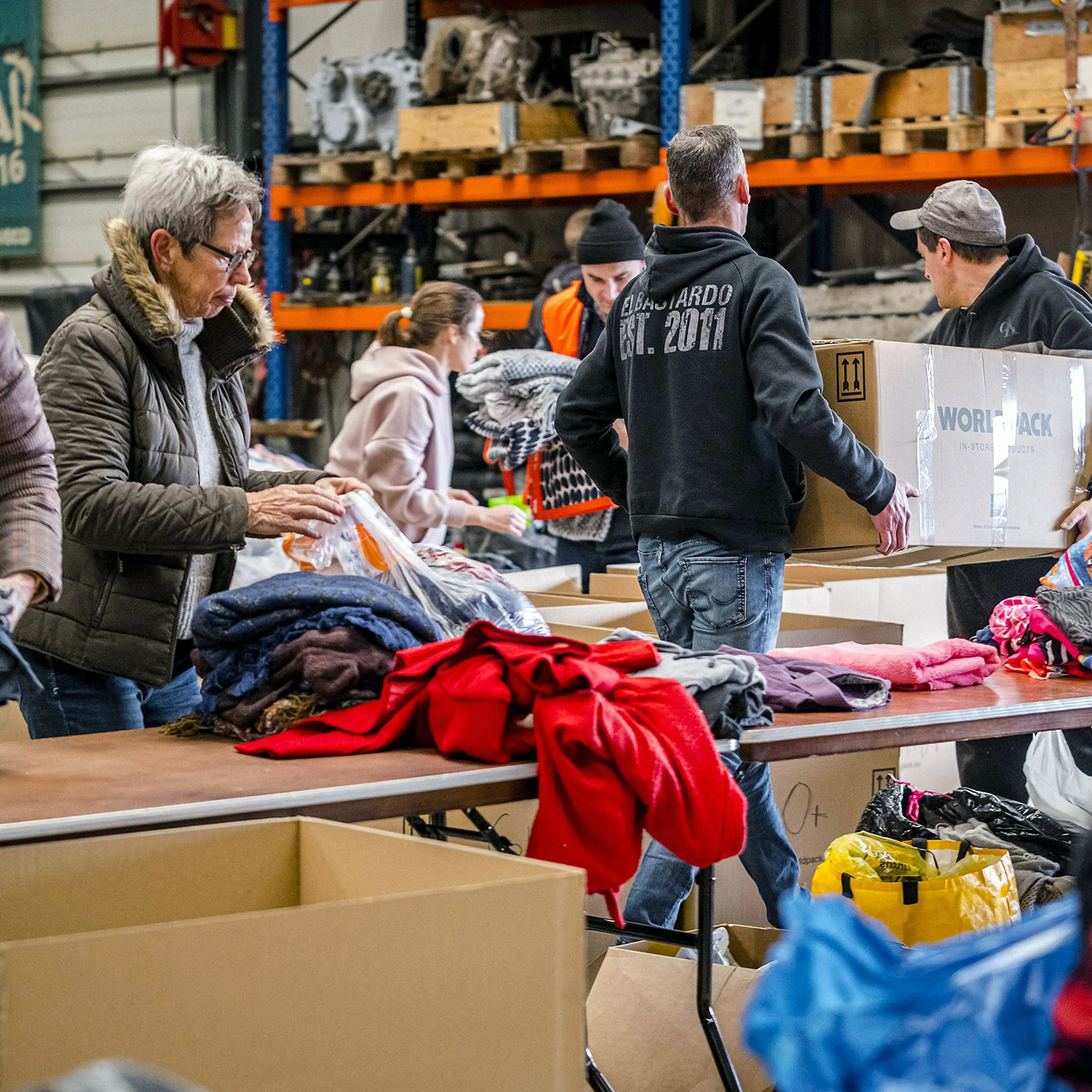 Volunteers collect and pack household necessities to be sent to Ukraine