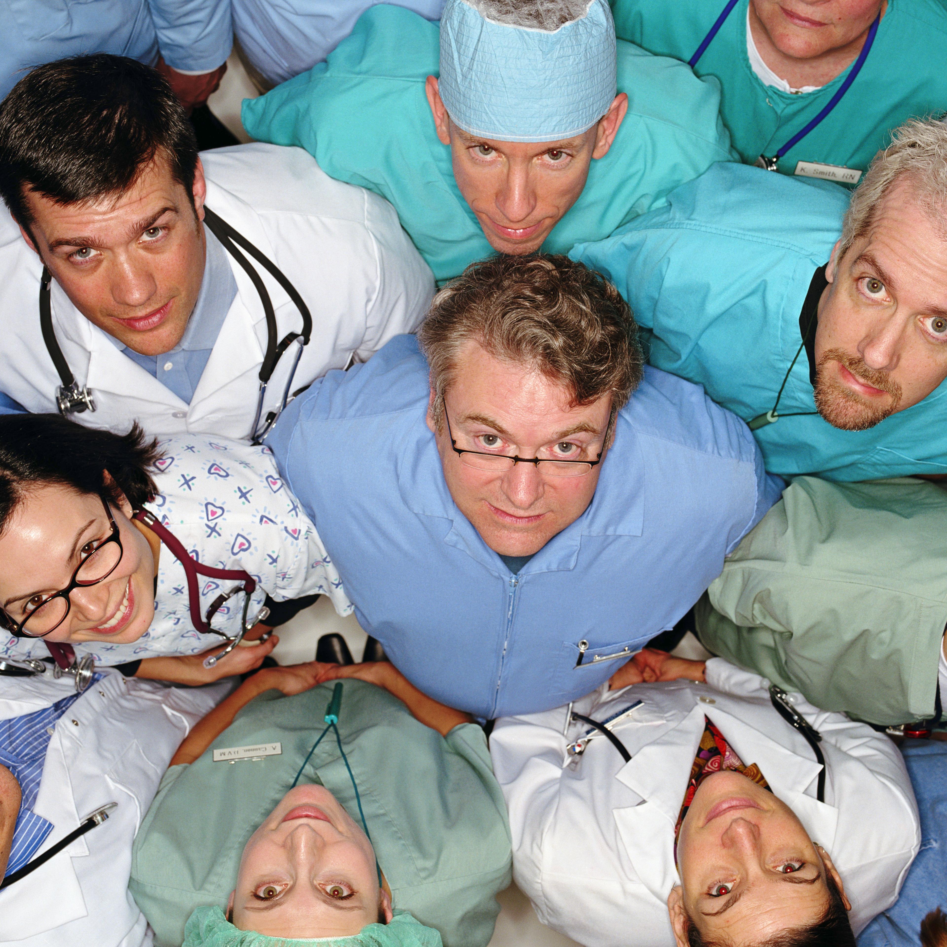 Group of healthcare professionals looking up, overhead view