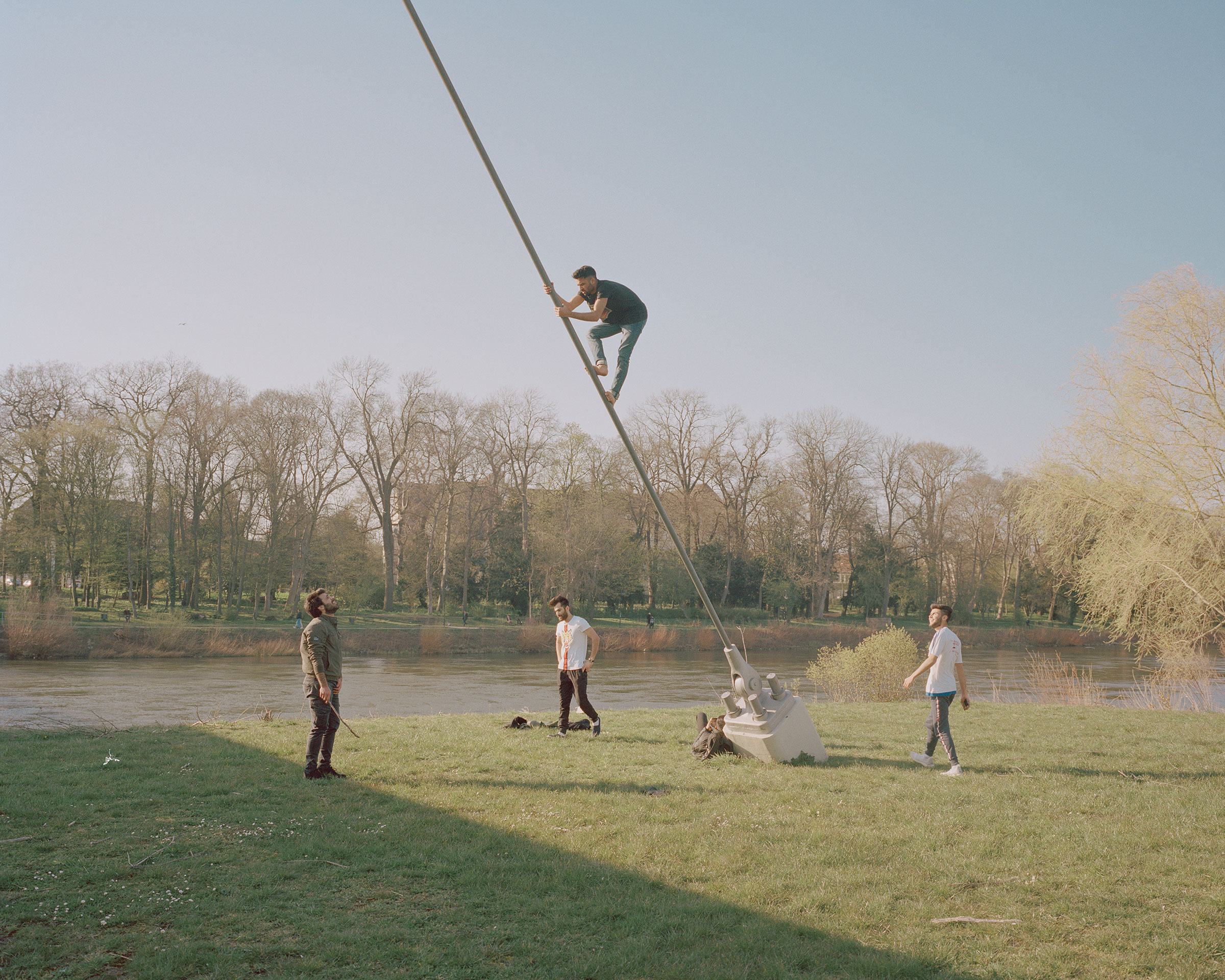 Young men fool around on the banks of the river Weser in Minden on April 8.