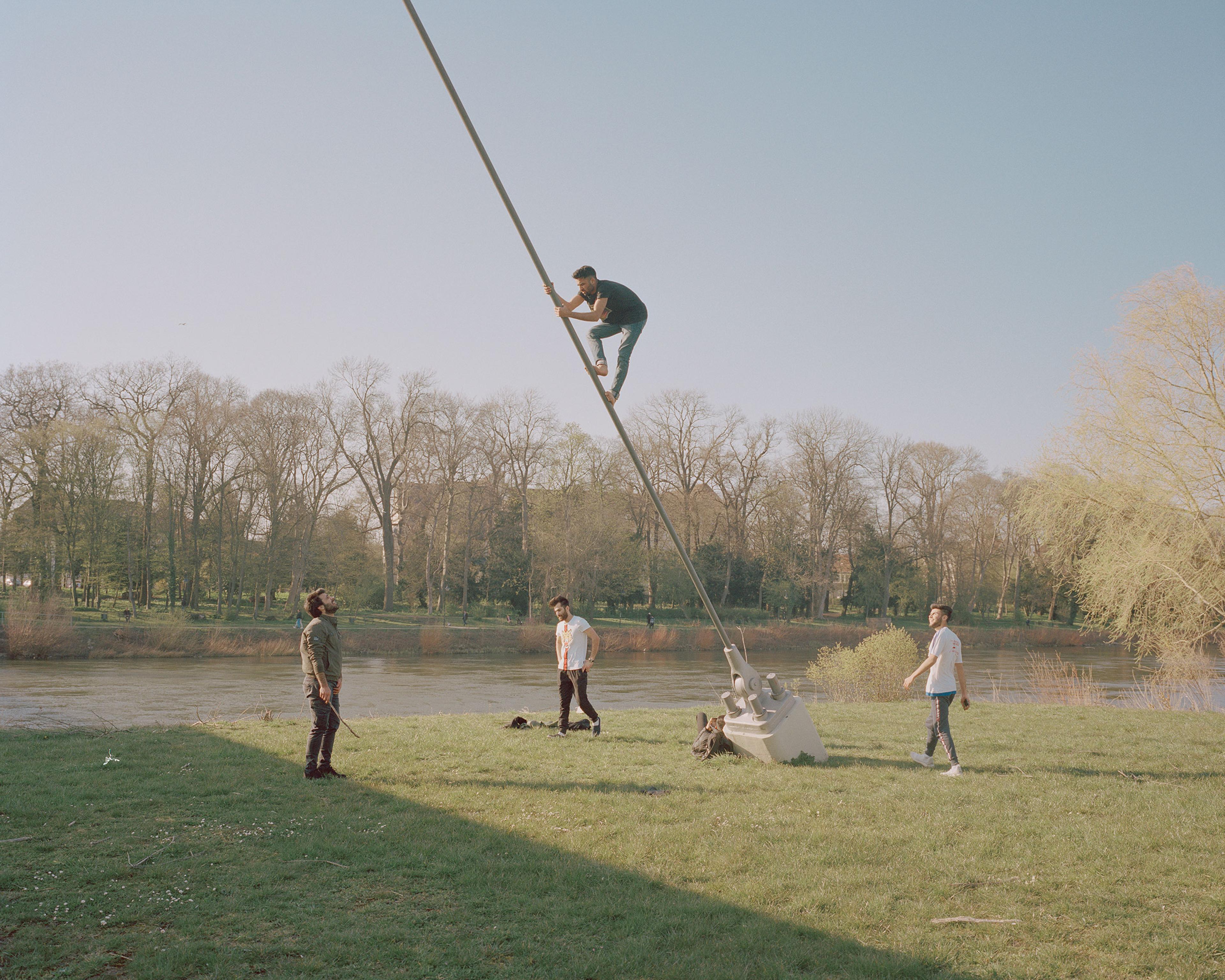 Young men fool around on the banks of the river Weser in Minden on April 8.