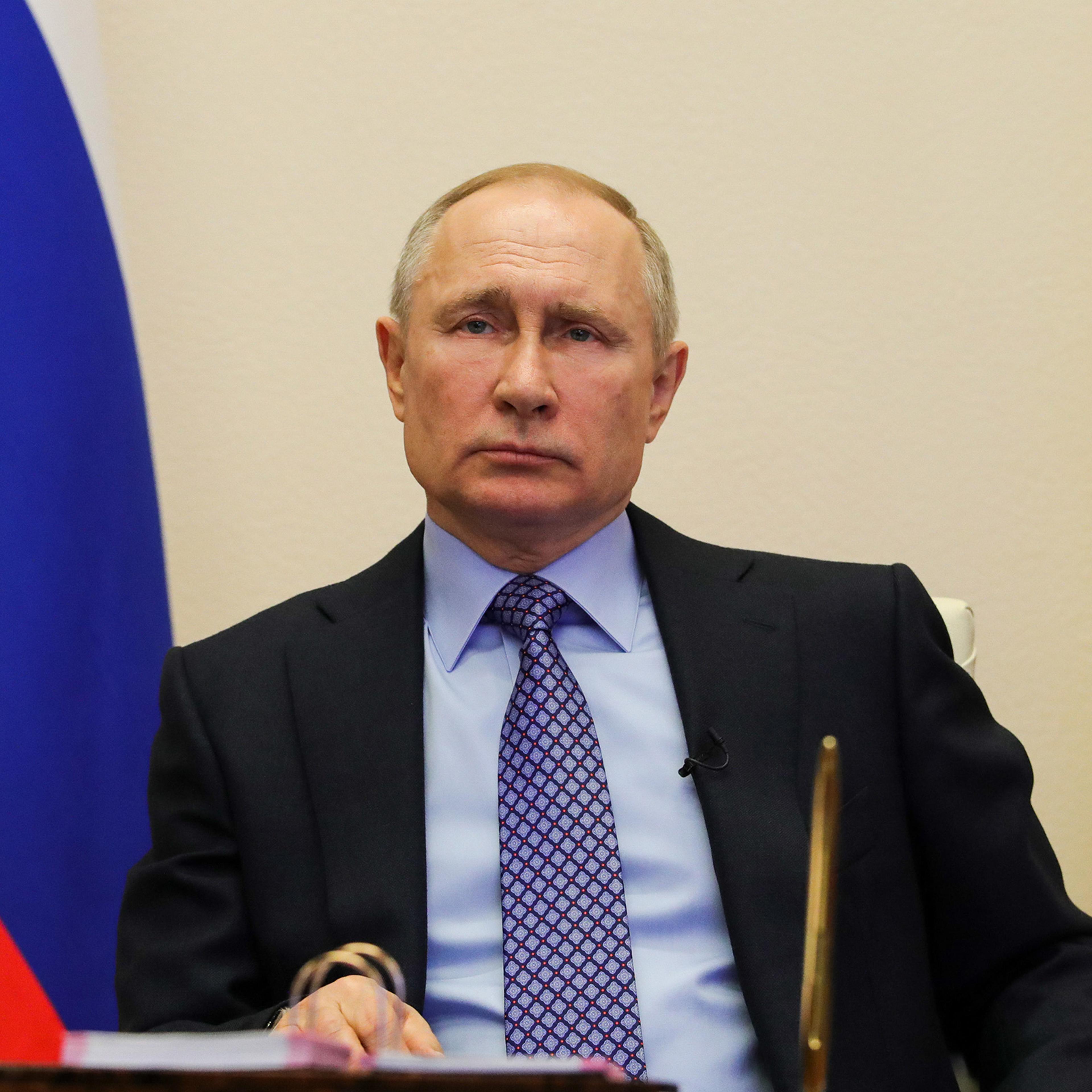 Vladimir Putin attends a meeting with regional officials via tele link in his residence on March 30