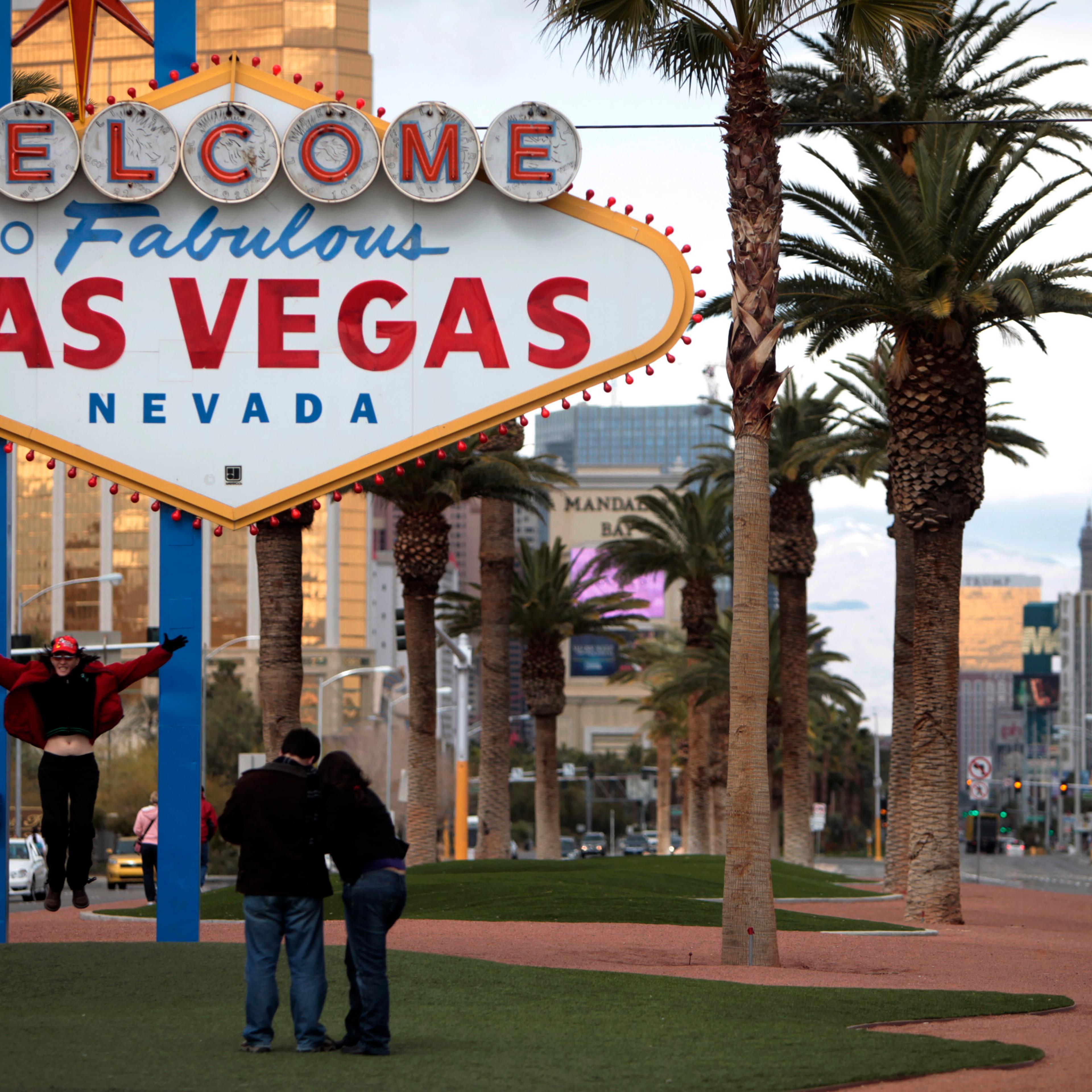 Tourists take pictures on Feb 12, 2009 in front of the "Welcome to Fabulous Las Vegas" neon sign in Las Vegas. Betty Willis, the woman who designed the iconic neon sign that has welcomed countless visitors to Las Vegas since 1959 has died.
