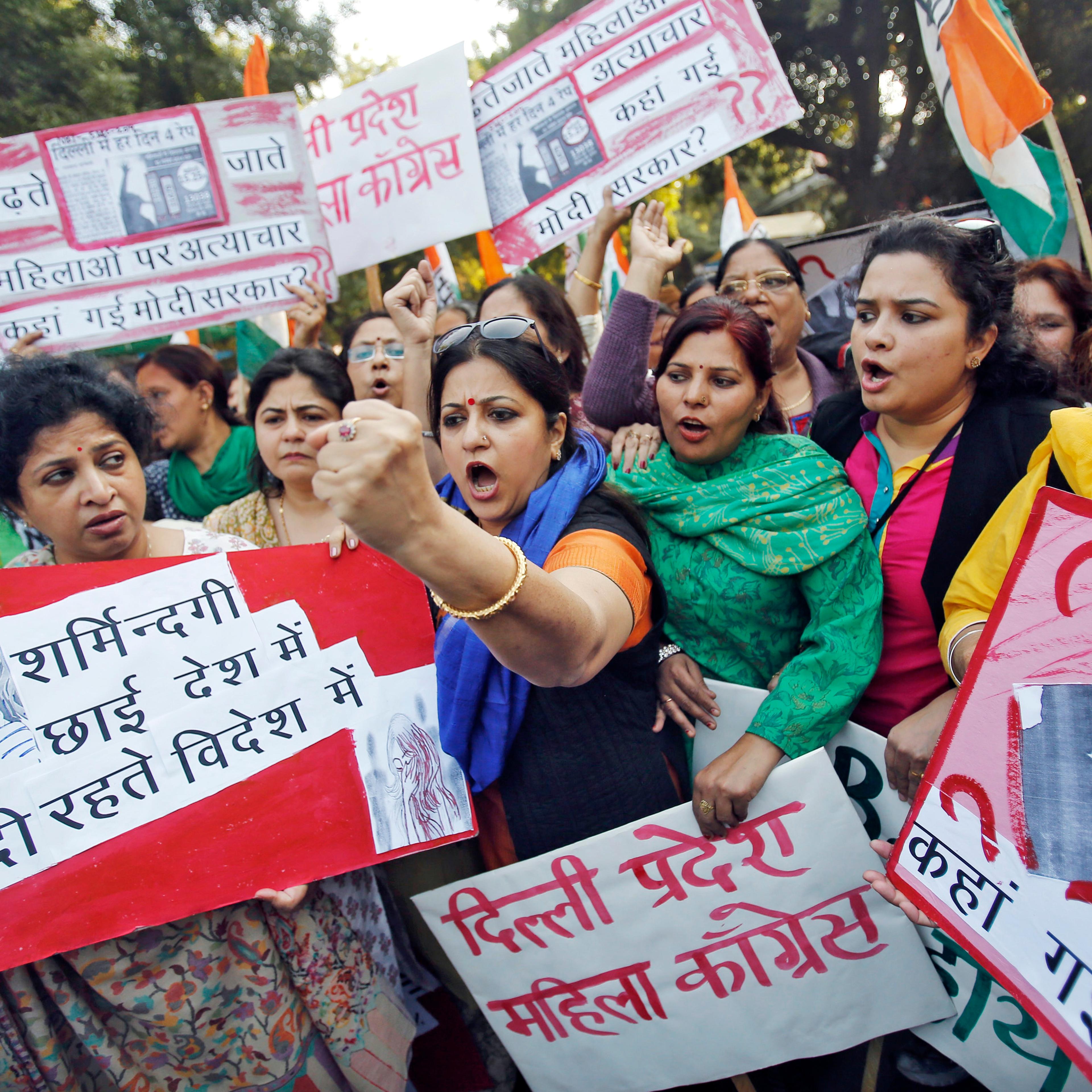 Members of All India Mahila Congress, women's wing of Congress party, shout slogans and carry placards during a protest against the rape of a female passenger, in New Delhi