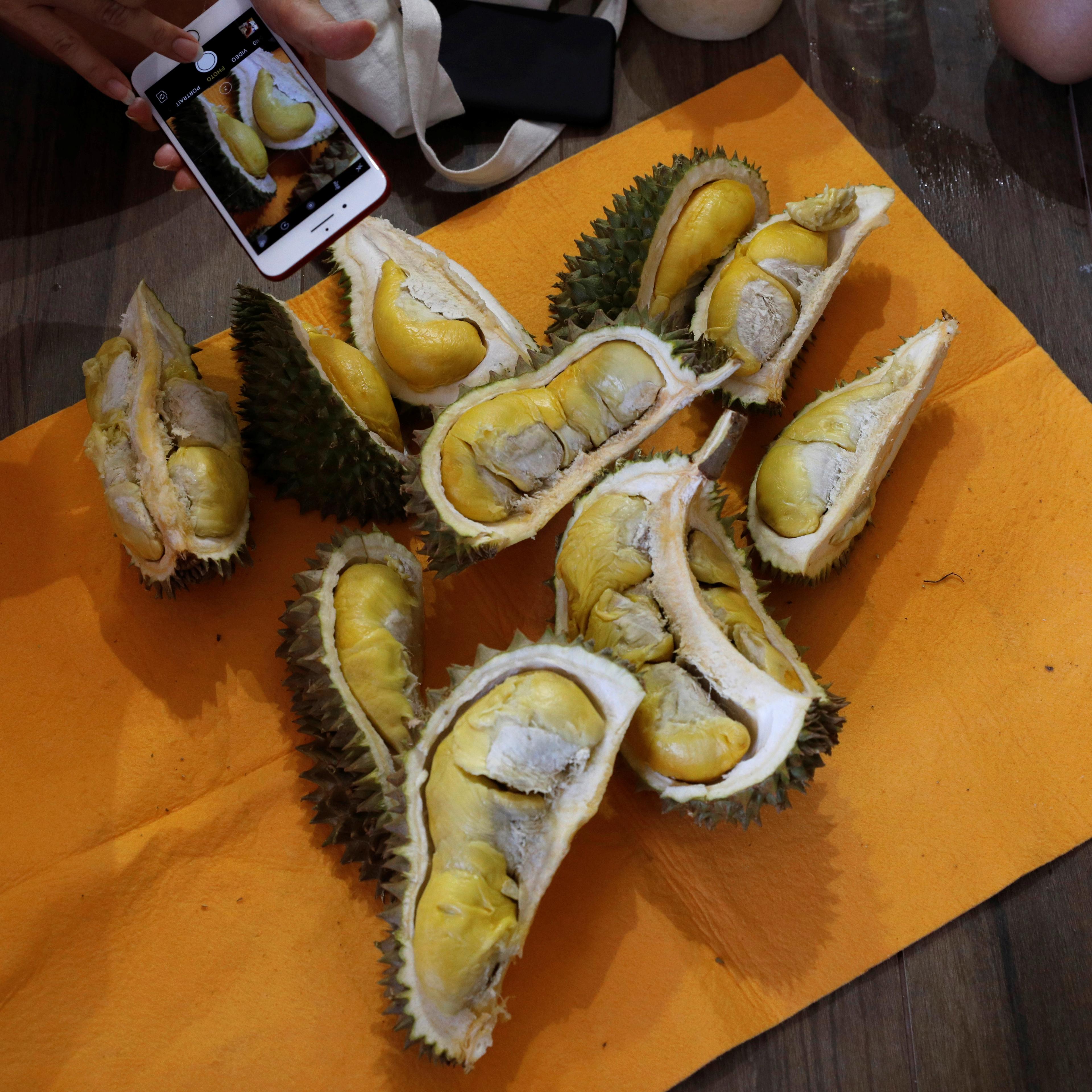 Participants take photos of their durians after the Durian Run in Singapore