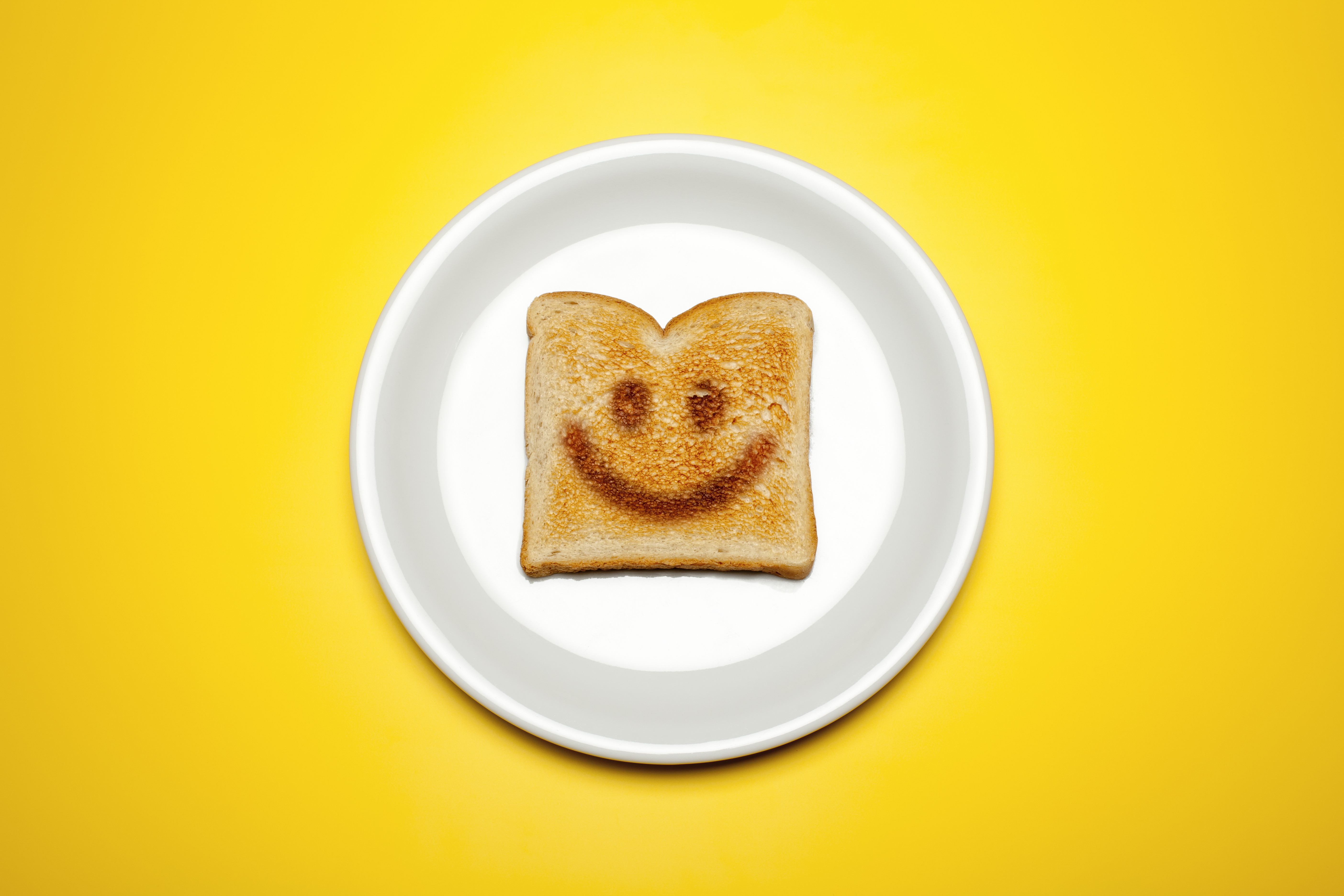 Smiley face toast on a plate