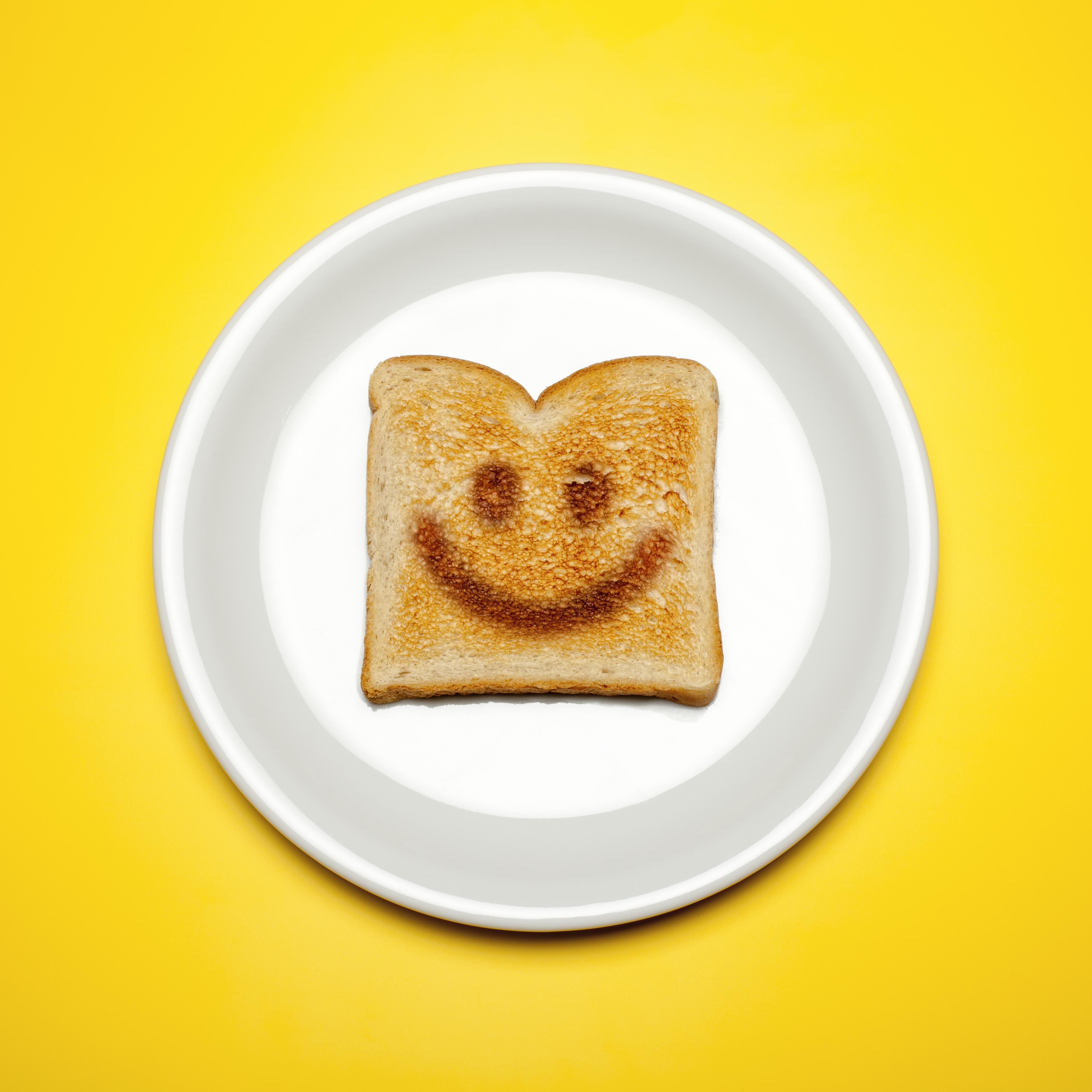 Smiley face toast on a plate