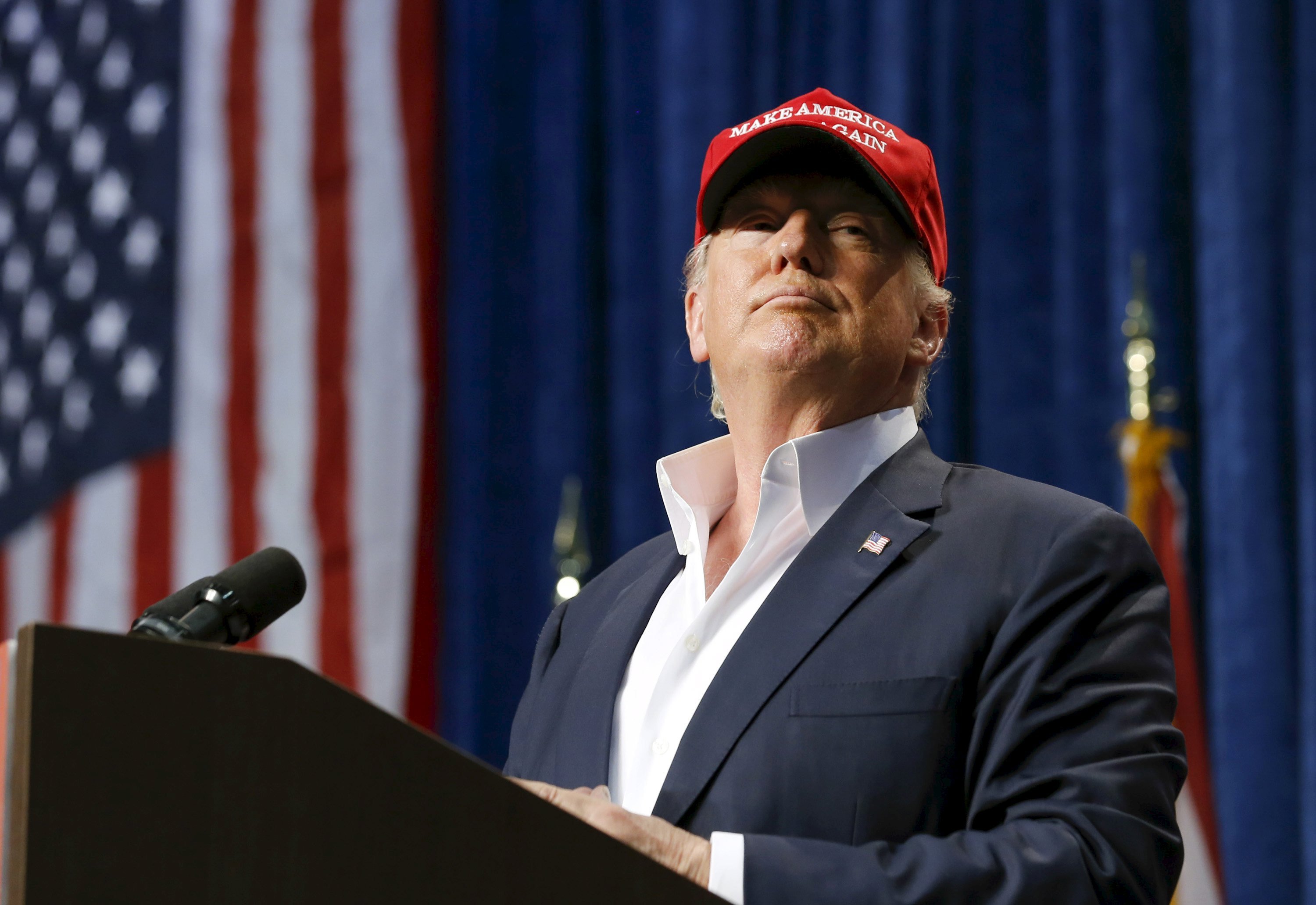 U.S. Republican presidential candidate Donald Trump watches as a member of the audience is removed from his rally in Sarasota, Florida