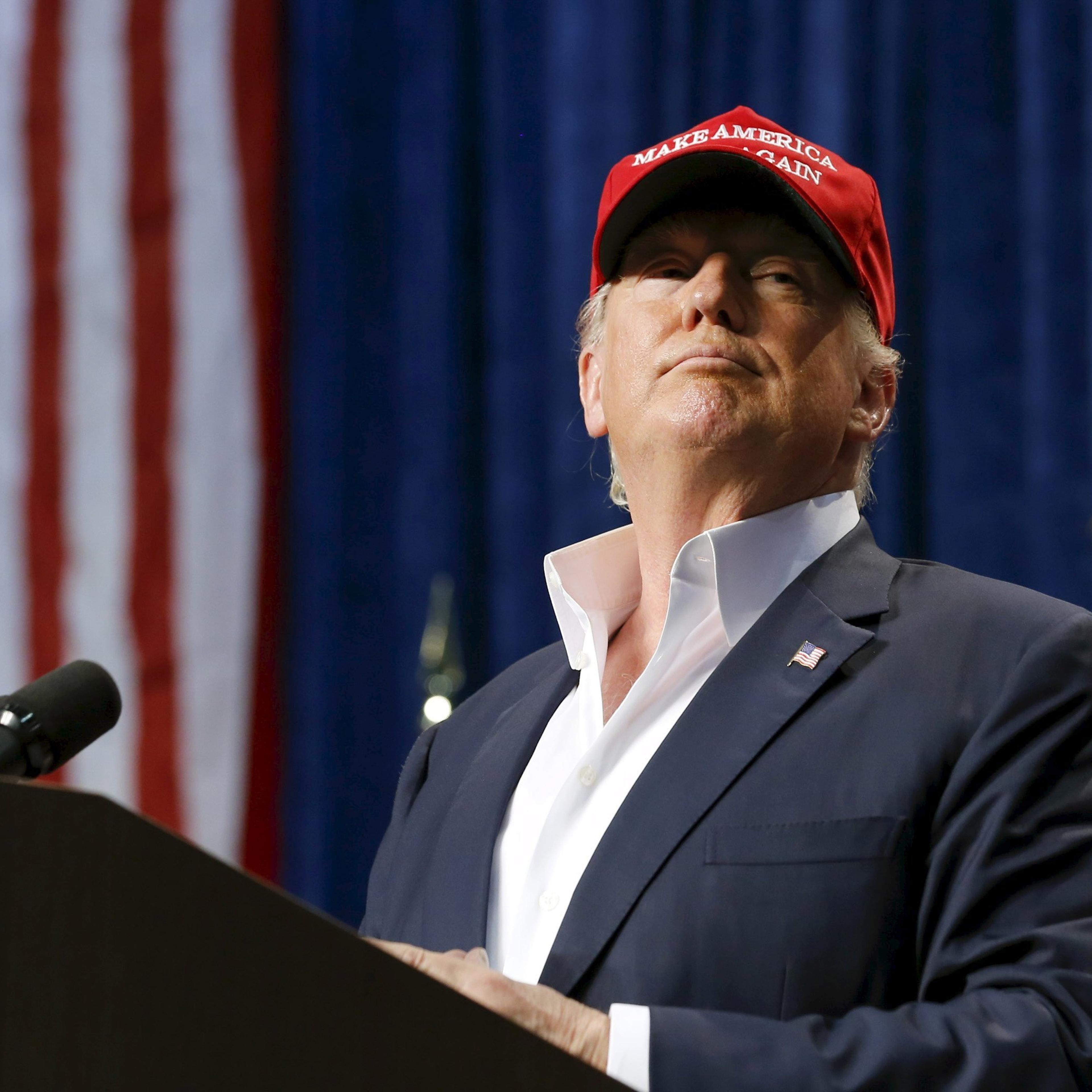 U.S. Republican presidential candidate Donald Trump watches as a member of the audience is removed from his rally in Sarasota, Florida