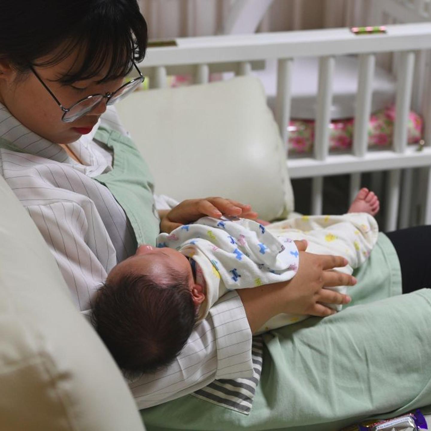 A social worker cares for a baby at the Jusarang Community Church in southern Seoul on May 24, 2017.
