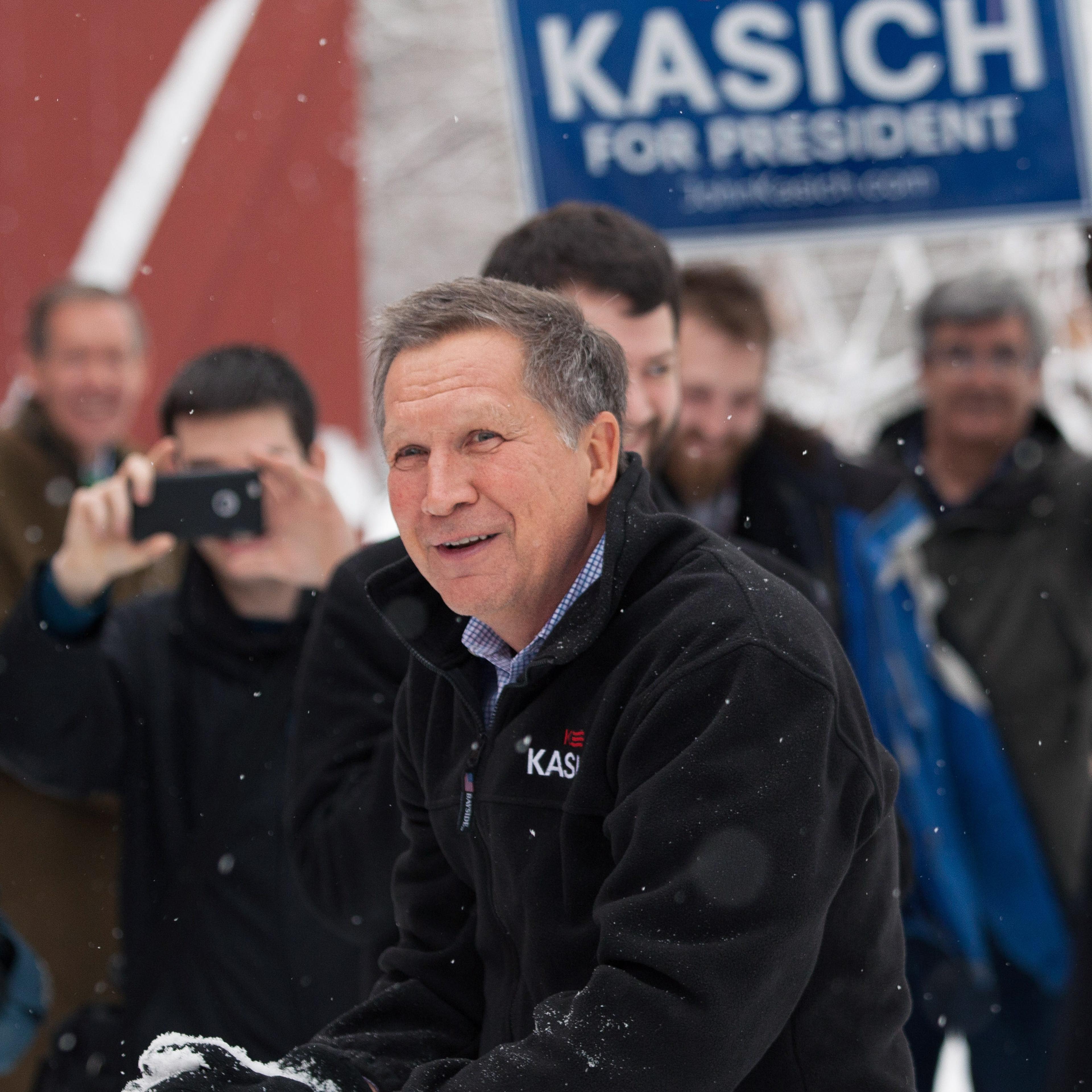 HOLLIS, NH - FEBRUARY 05: Ohio Governor and Republican presidential candidate John Kasich smiles during a snowball fight with his staff following a town hall style meeting on February 5, 2016 in Hollis, New Hampshire. Democratic and Republican Presidenti