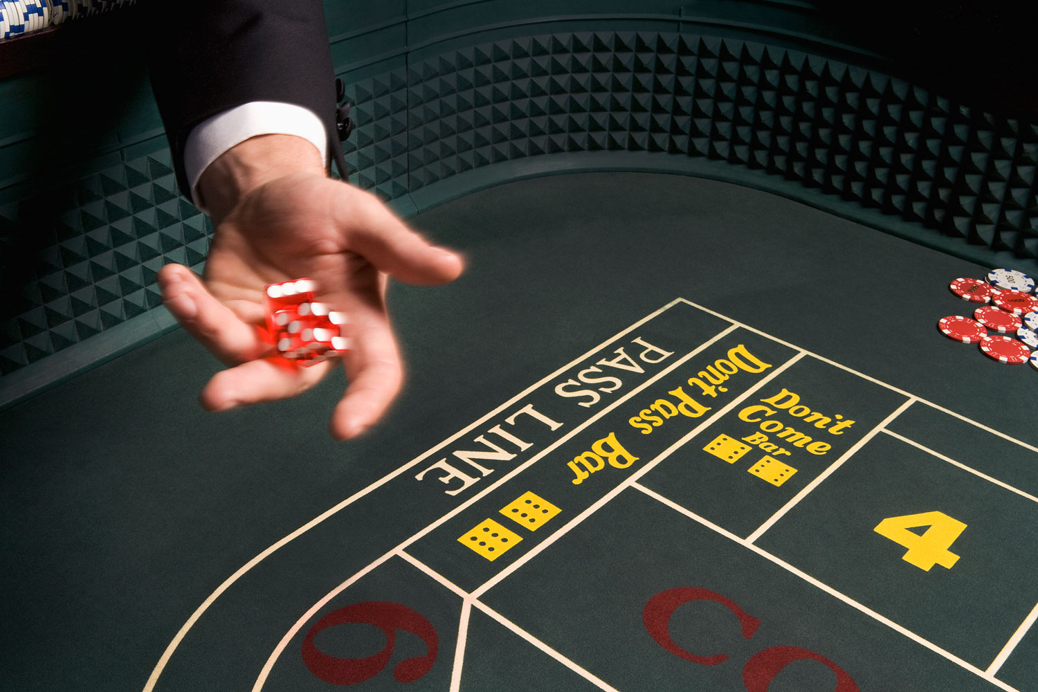 Man throwing dice at craps table