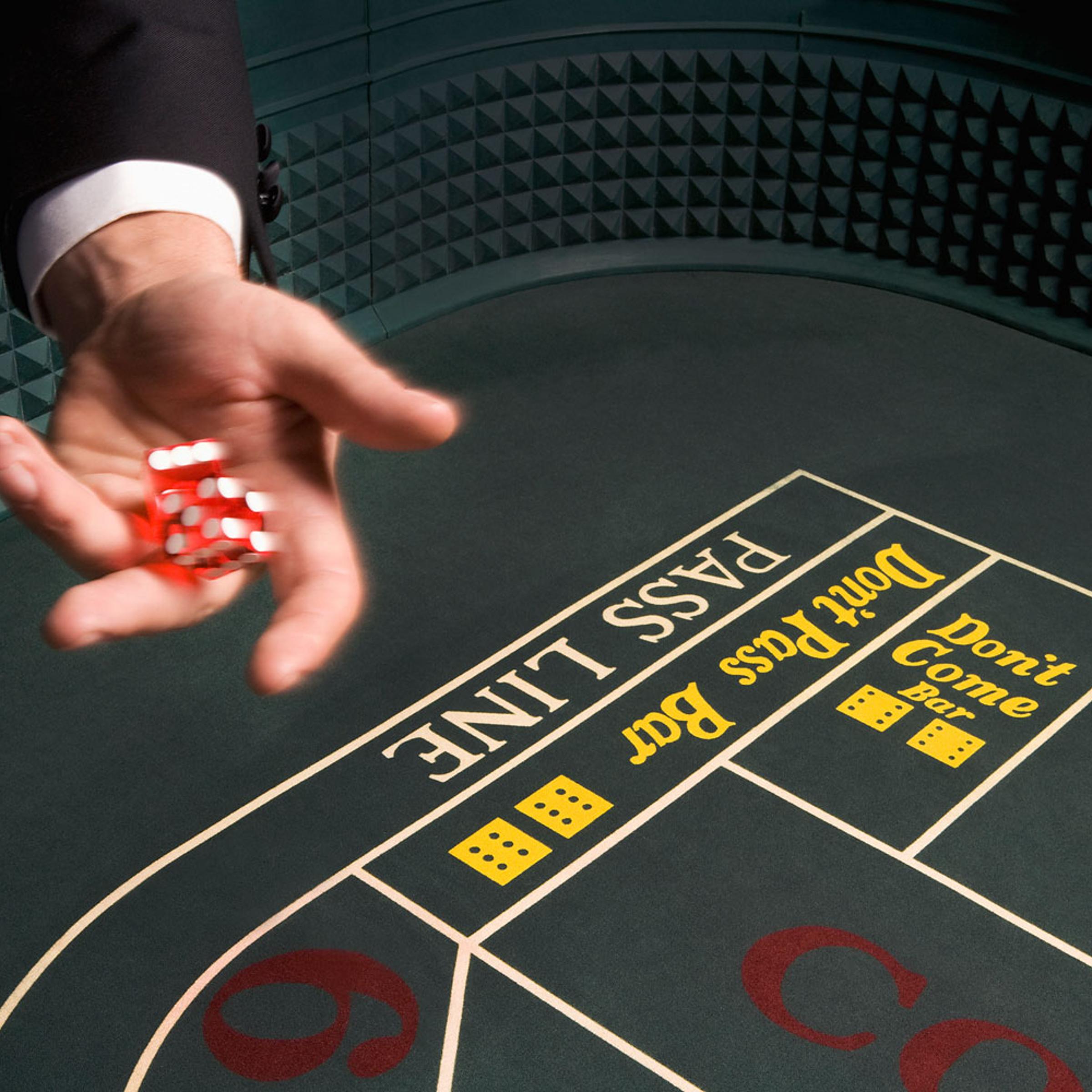 Man throwing dice at craps table
