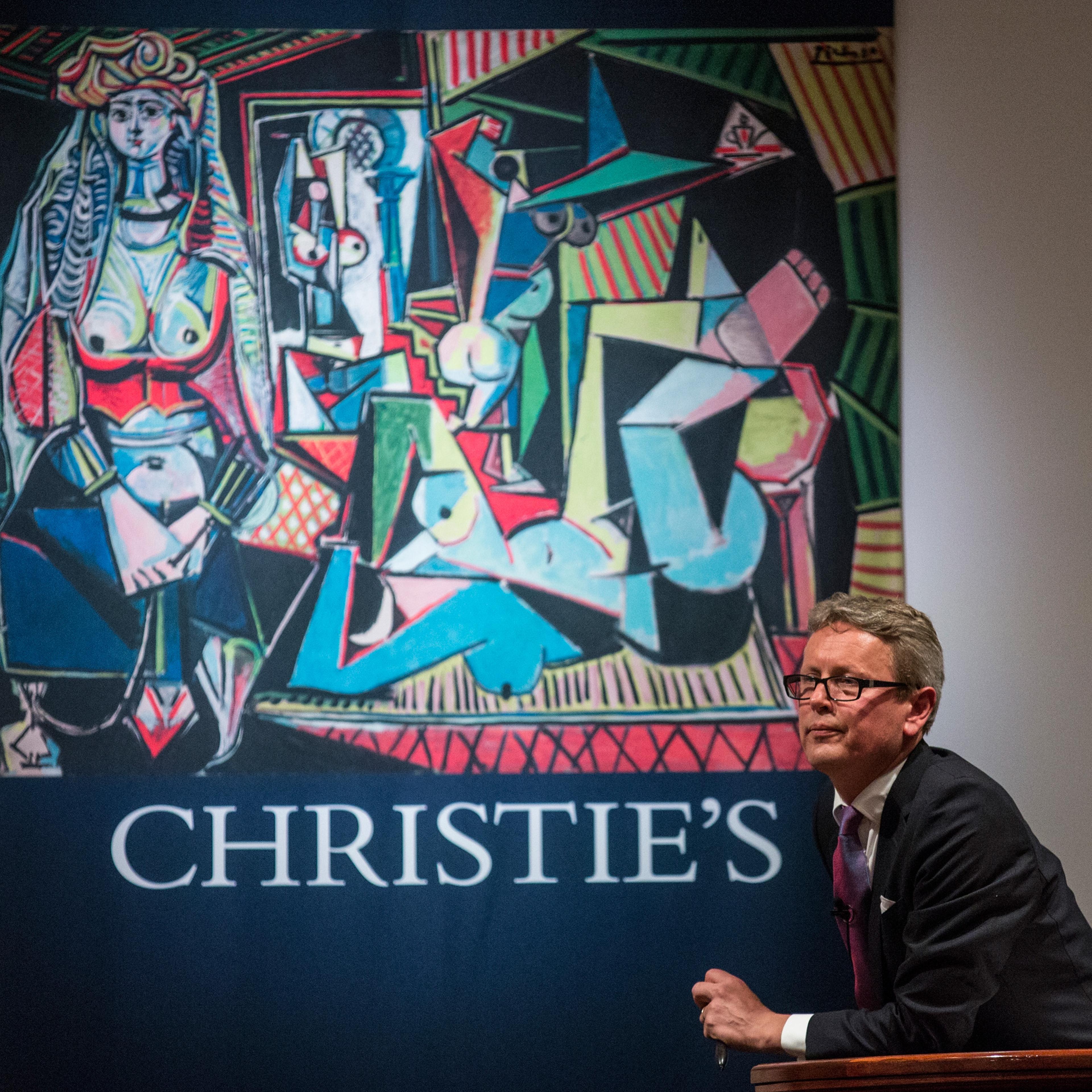Jussi Pylkkanen, president of Christie's, takes bids at an auction for the art work, "Les femmes d'Alger (Version O)" painted by Pablo Picasso, at Christie's on May 11, 2015 in New York City