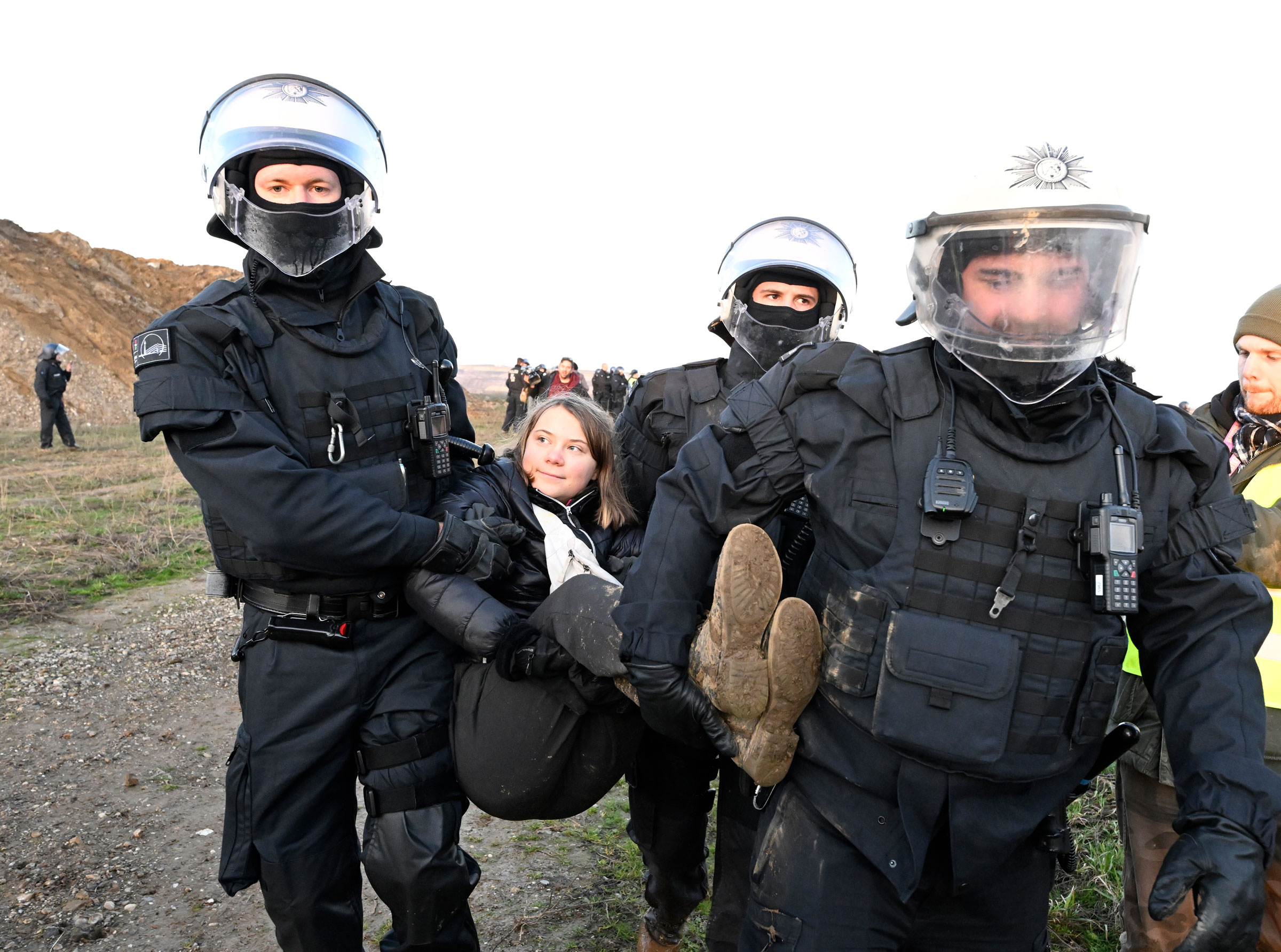 Police officers carry Swedish climate activist Greta Thunberg out of a group of protesters and activists and away from the edge of the Garzweiler II opencast lignite mine during protests in North Rhine-Westphalia, Germany, on Jan. 17, 2023.