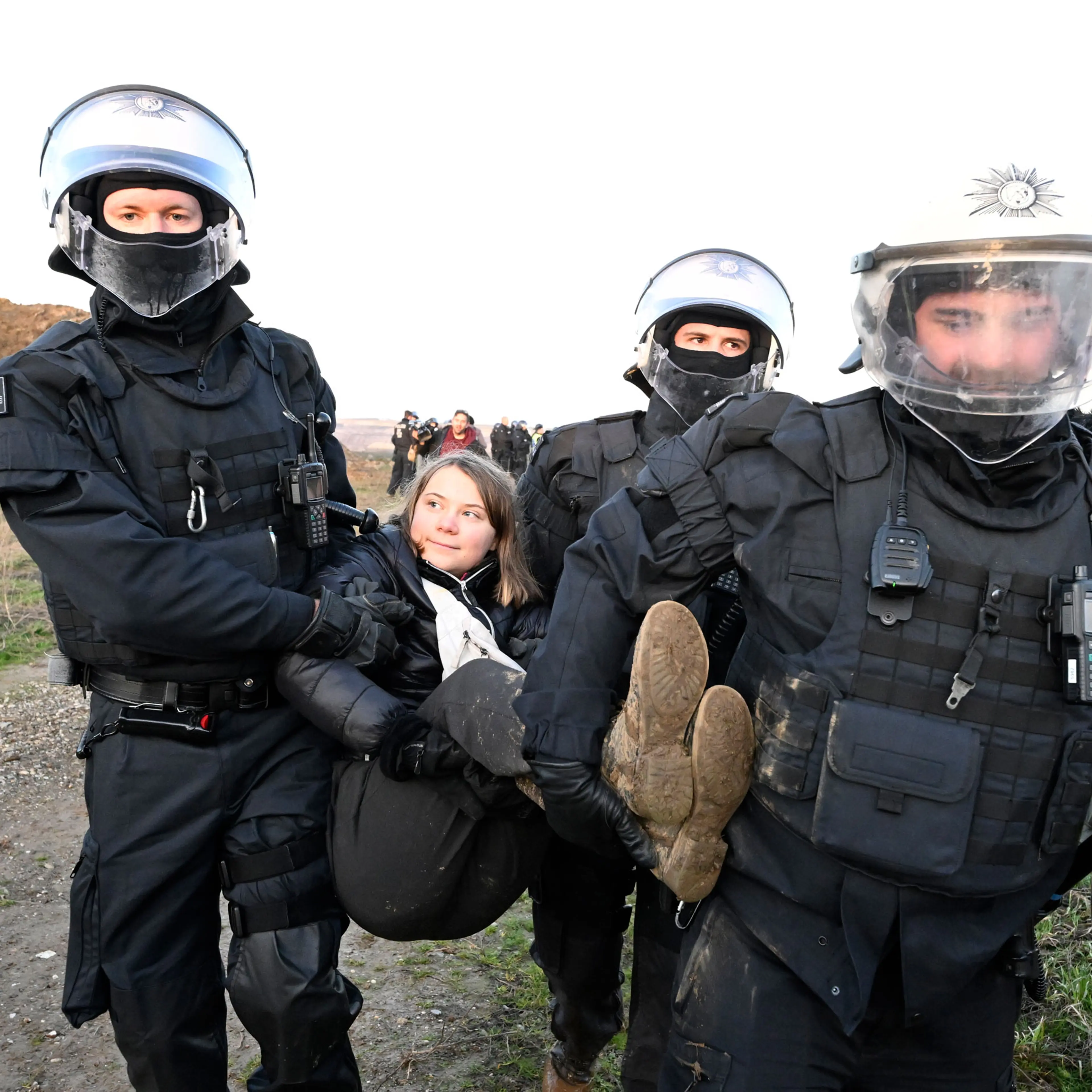 Police officers carry Swedish climate activist Greta Thunberg out of a group of protesters and activists and away from the edge of the Garzweiler II opencast lignite mine during protests in North Rhine-Westphalia, Germany, on Jan. 17, 2023.