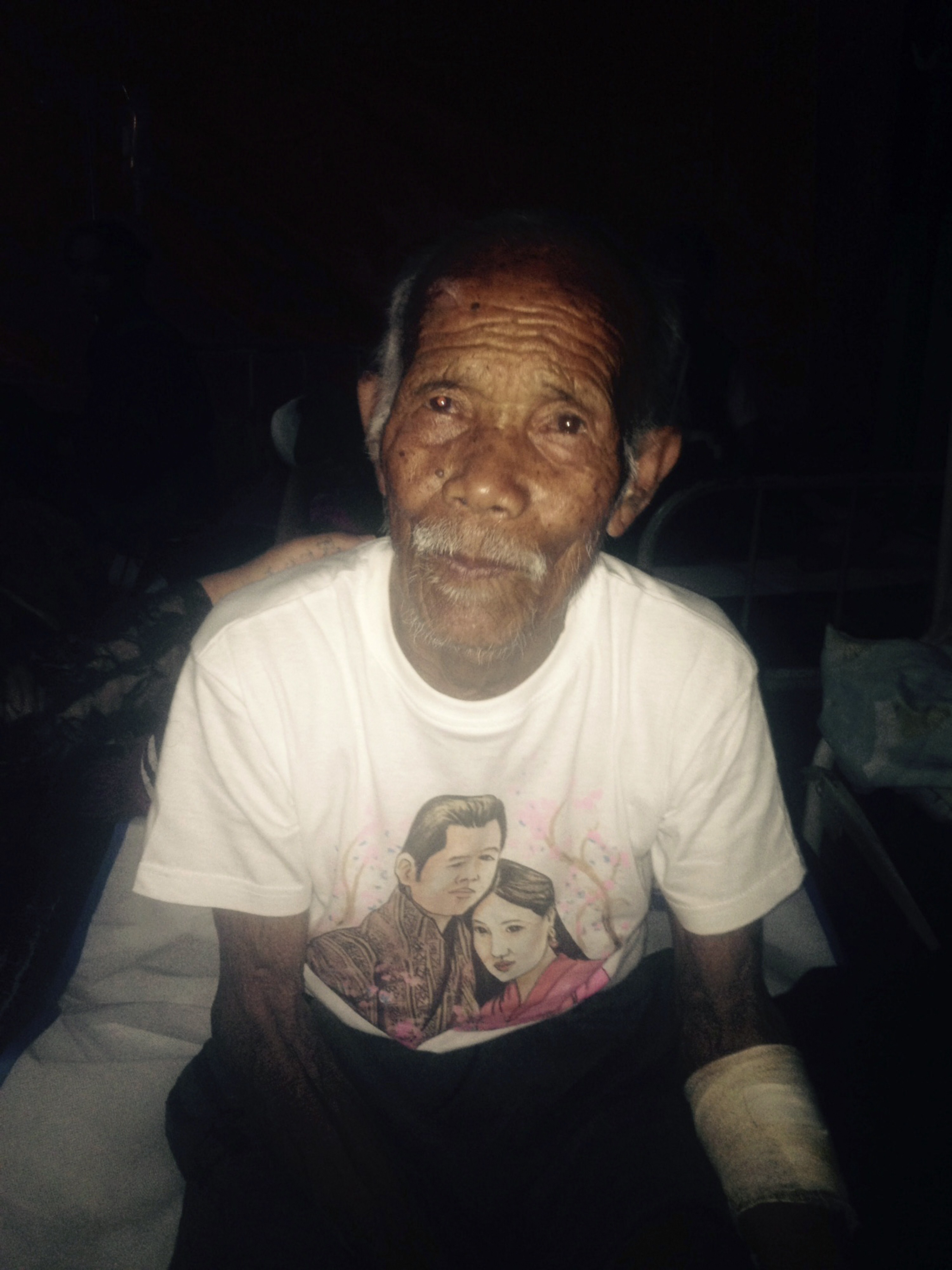 Funchu Tamang, 101, sits on a bed in a hospital in Nuwakot district northwest of Kathmandu where he was taken after being rescued from his collapsed home